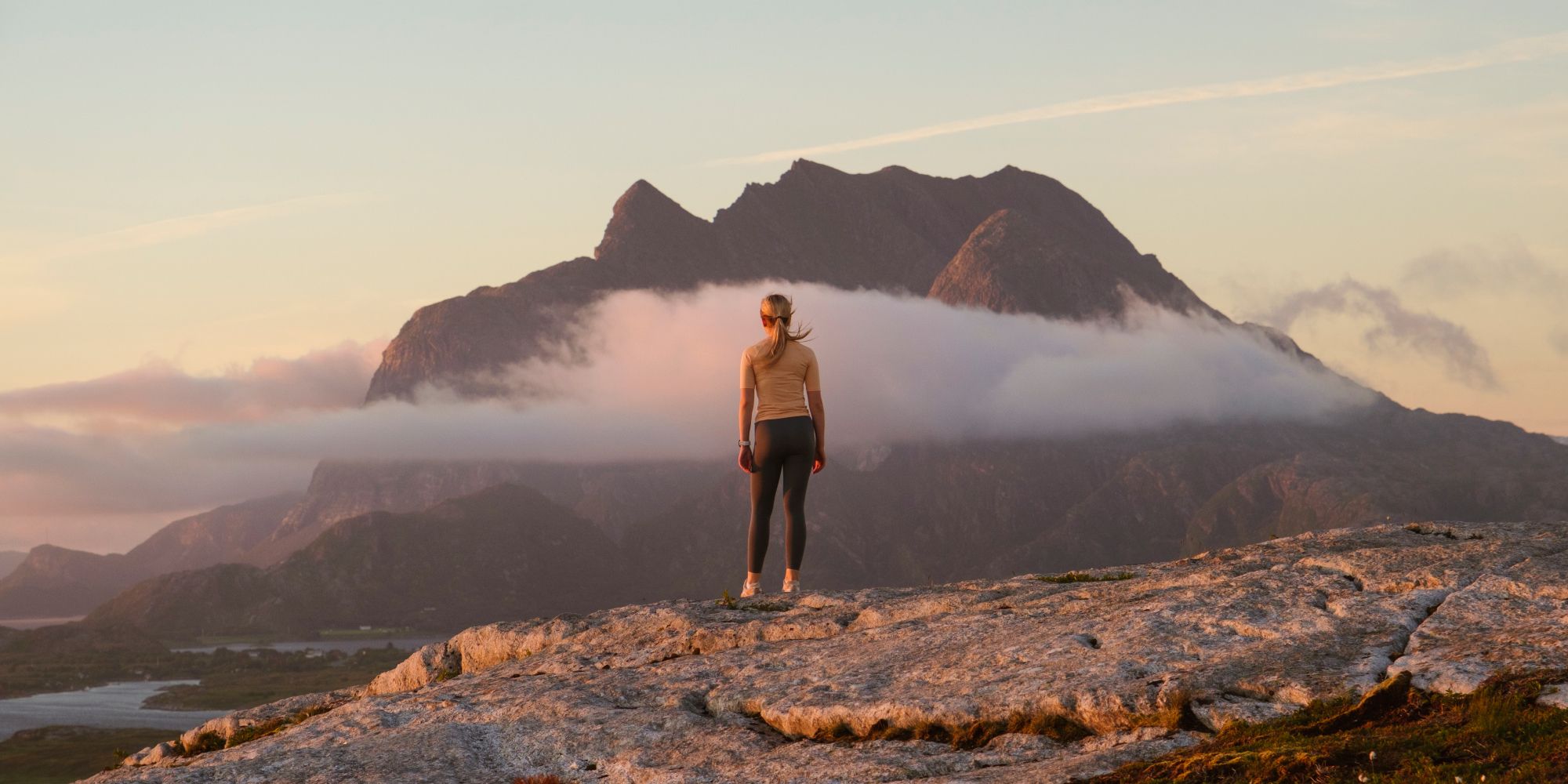A woman going on a midnight hike to Øksningan, Helgeland, Norway.