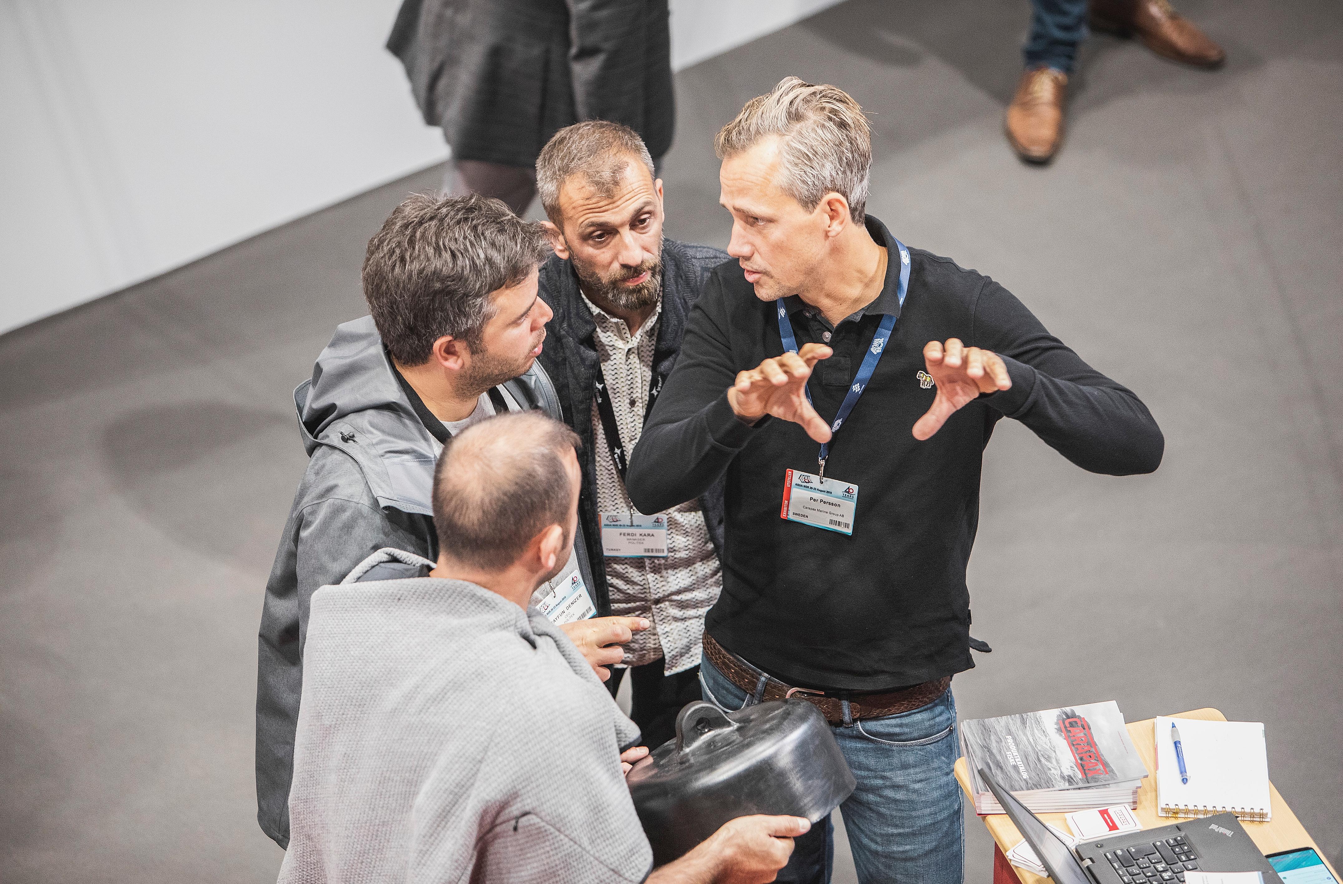 Four men in a conversation during Aqua Nor 2019 in Trondheim, Norway