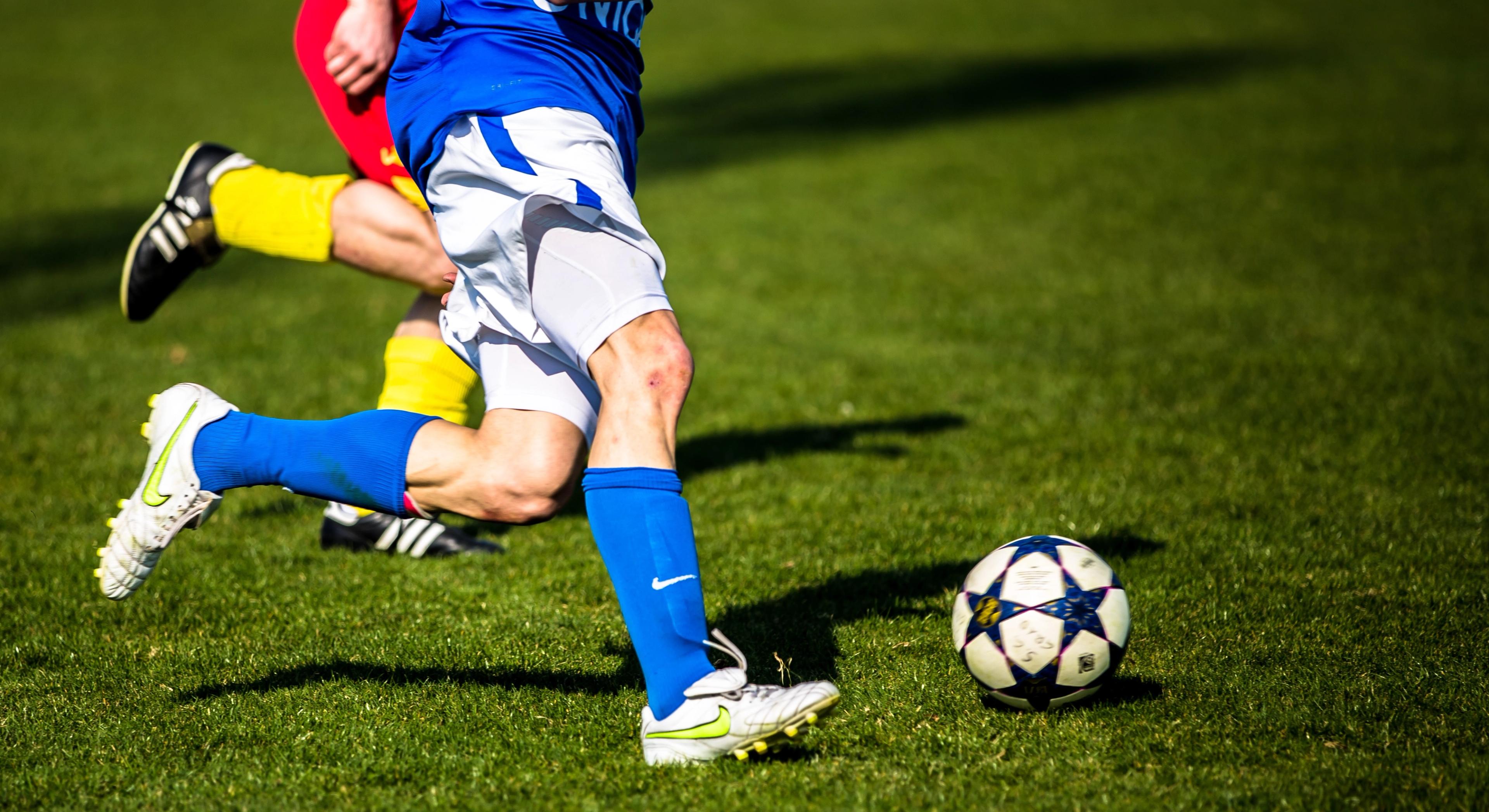 Two boys going for the football during a match at Norway Cup
