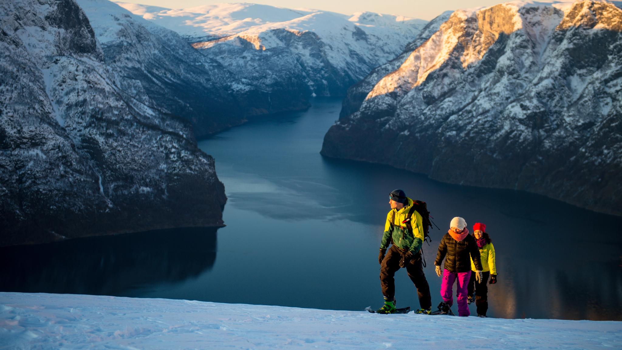 Three persons snowshoeing up Aurlandsfjellet