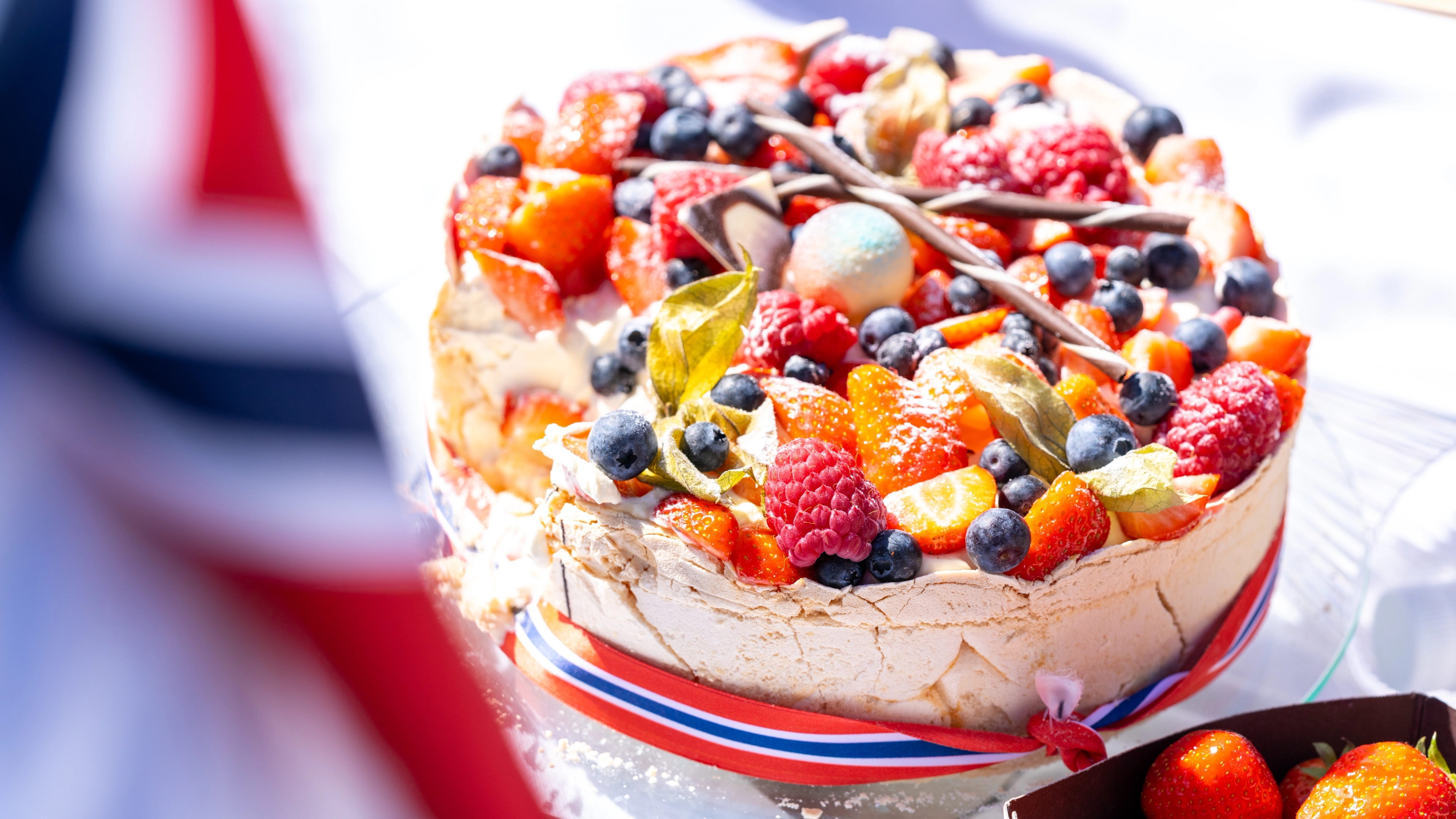 A classic pavlova cake decorated with the Norwegian flag on Norways national day