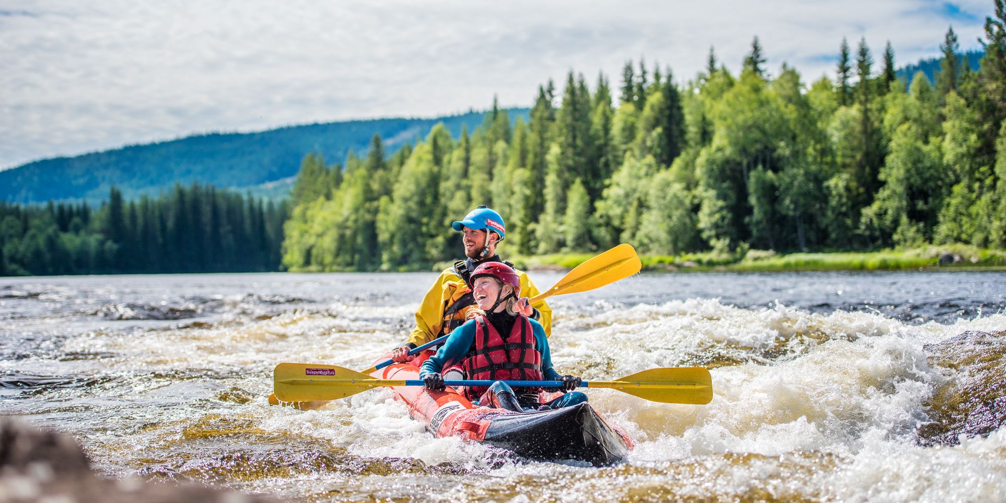 Two people packrafting down the river in Trysil, Eastern Norway