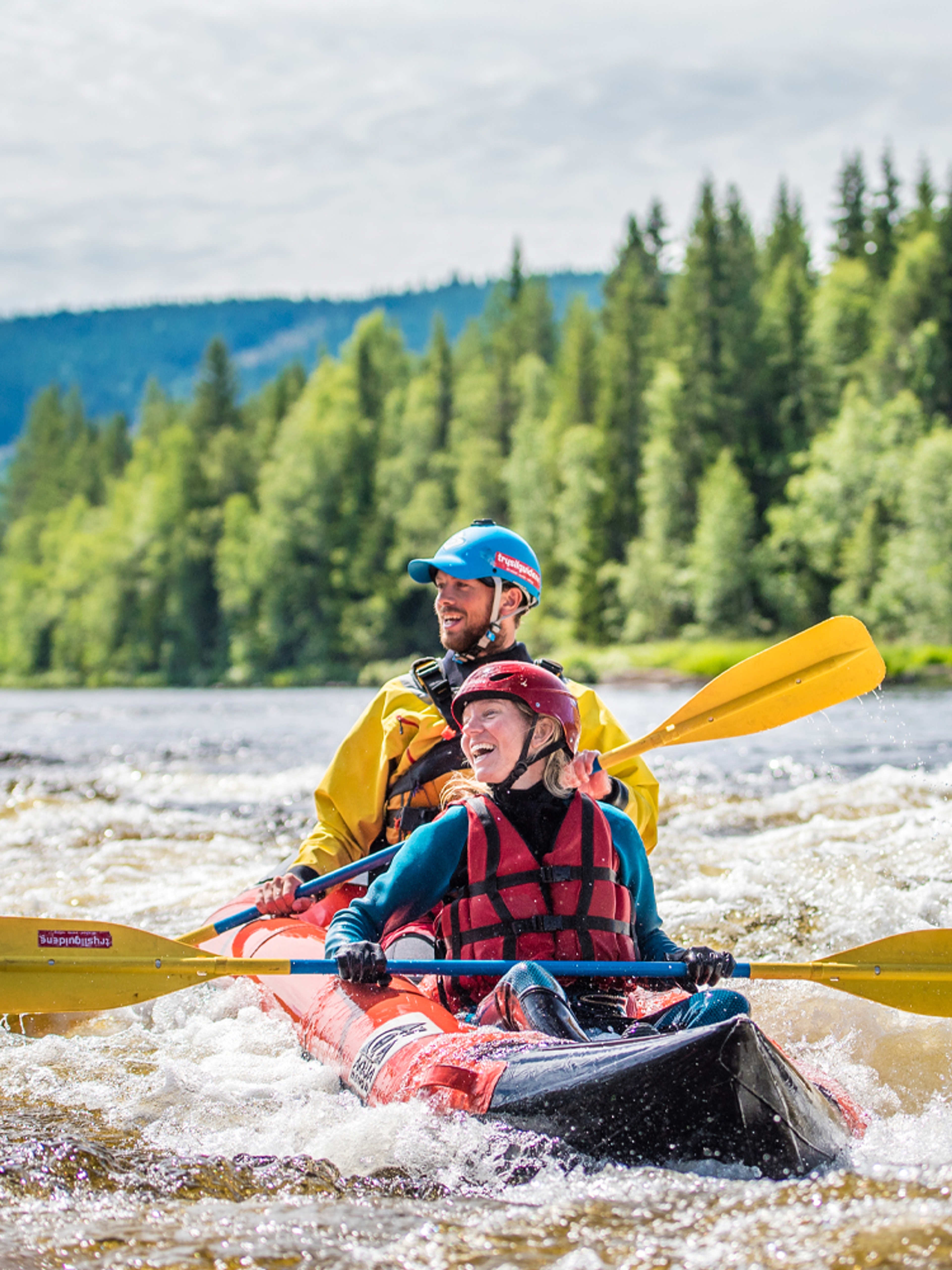 Two people packrafting down the river in Trysil, Eastern Norway