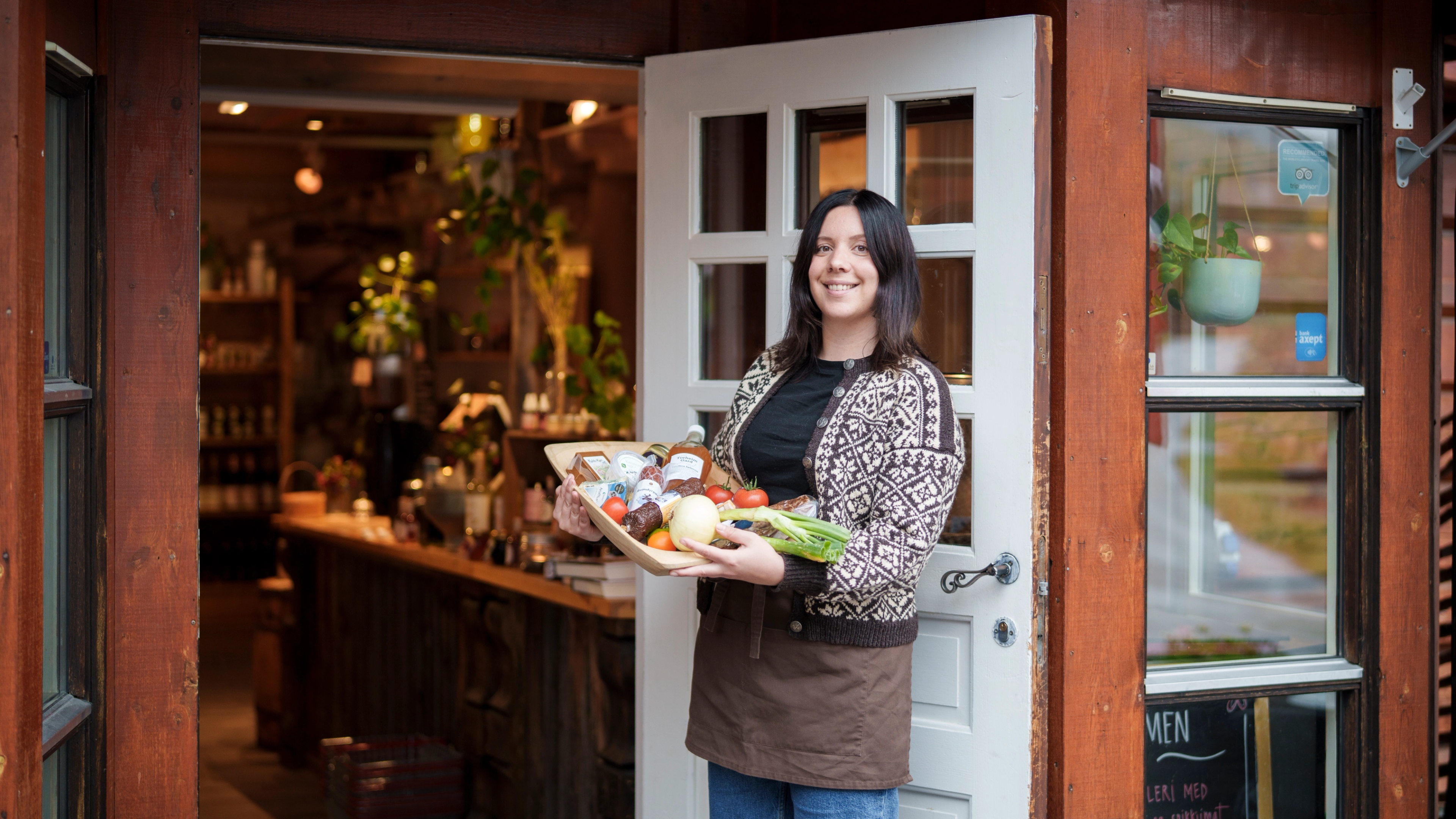 A woman holding a tray with local products.