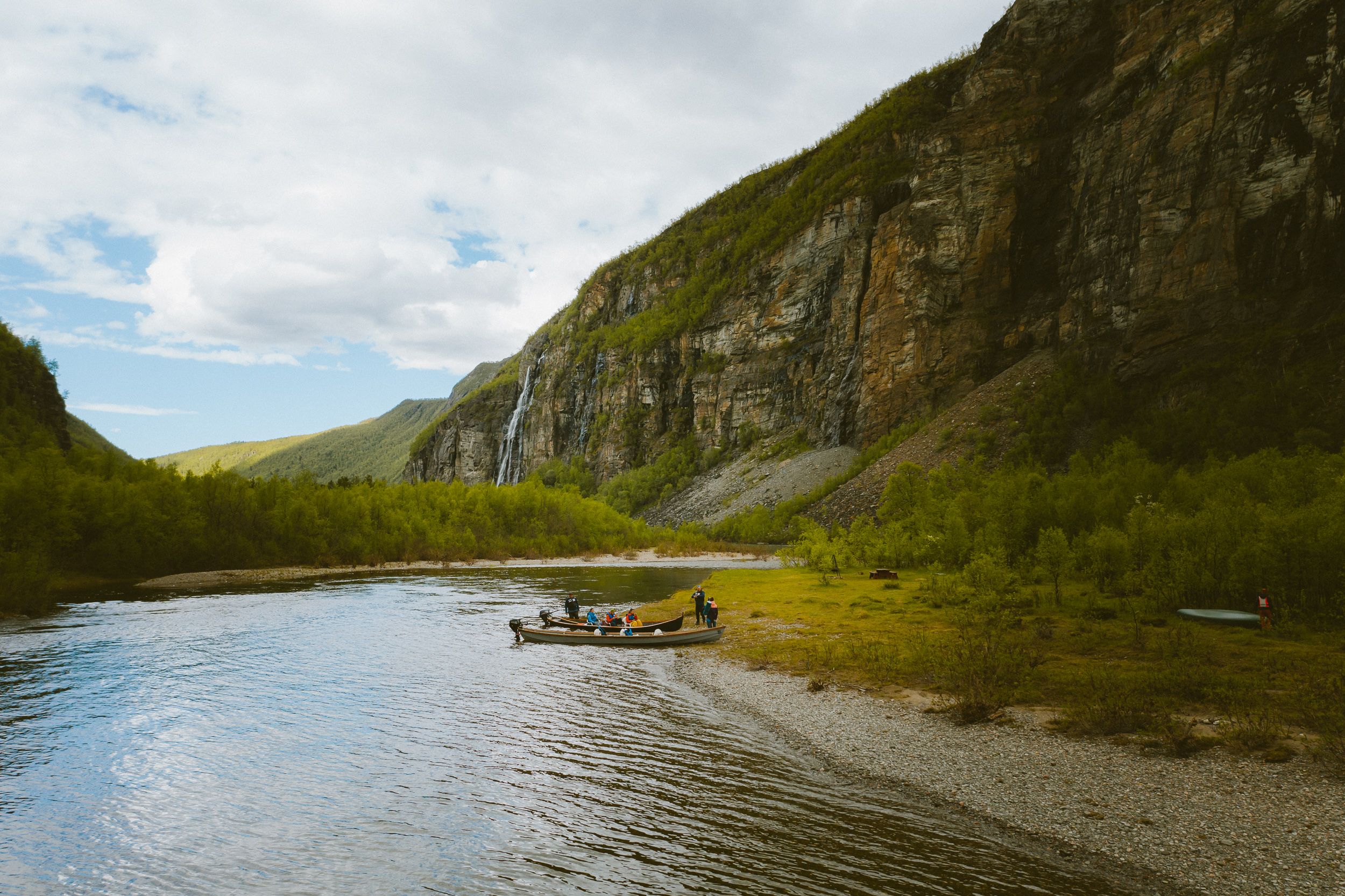 A group of people around two boats in Lyngenfjord, Northern Norway