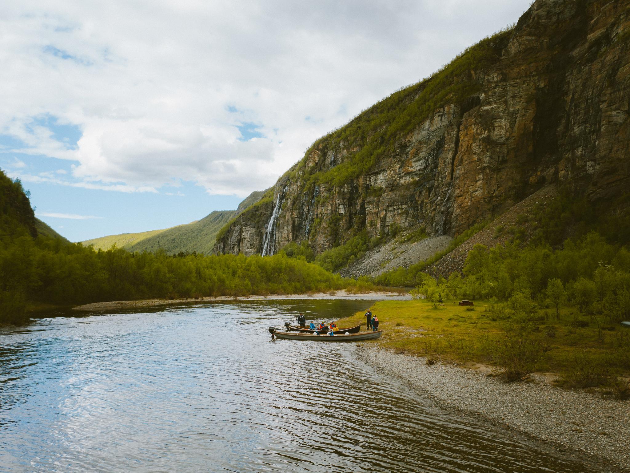A group of people around two boats in Lyngenfjord, Northern Norway