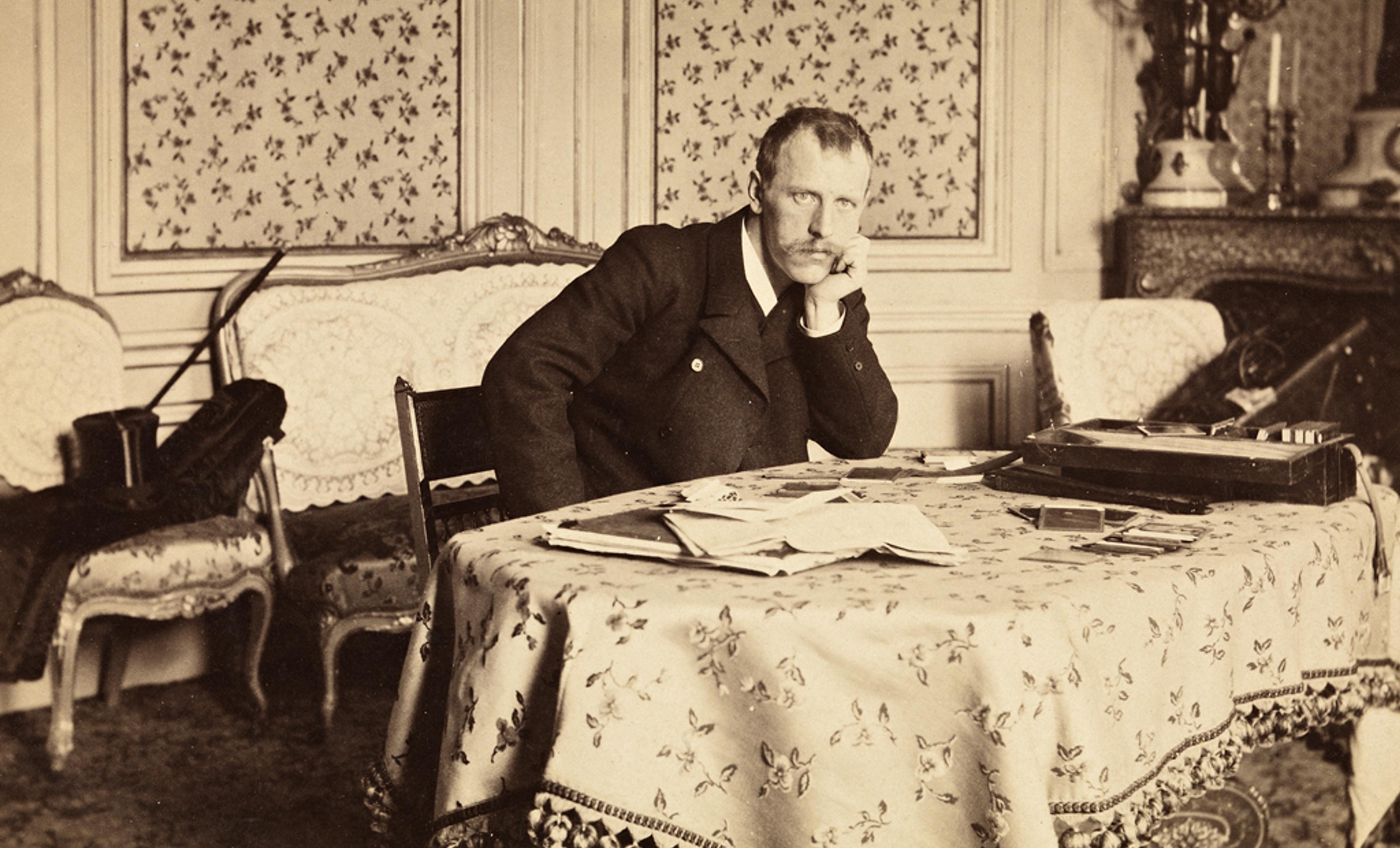 Fridtjof Nansen sitting at a table in Paris