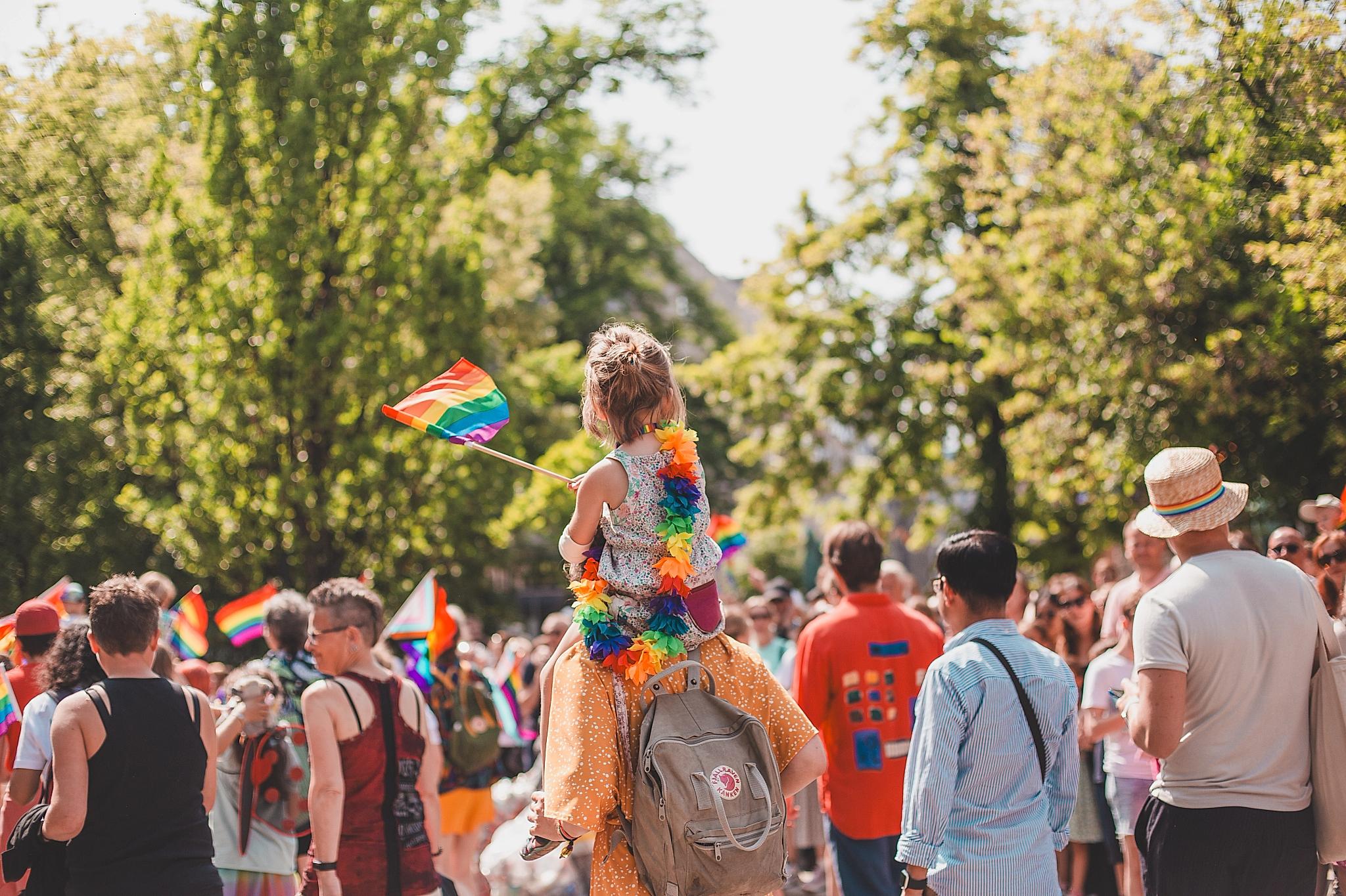 Little girl waiving pride flag at the Oslo Pride parade