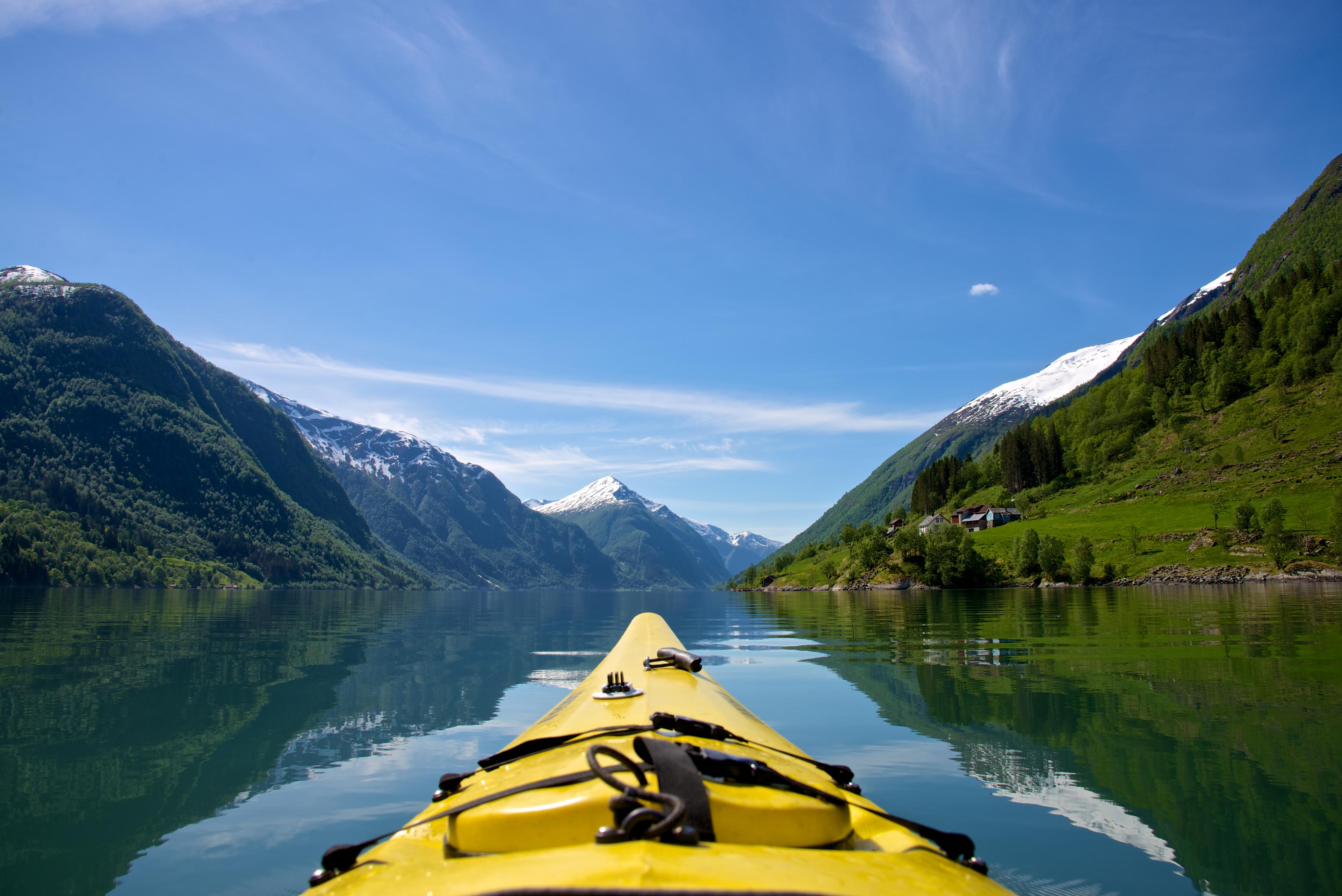 The tip of a kayak on Fjærlandsfjorden in Fjord Norway in a sunny day