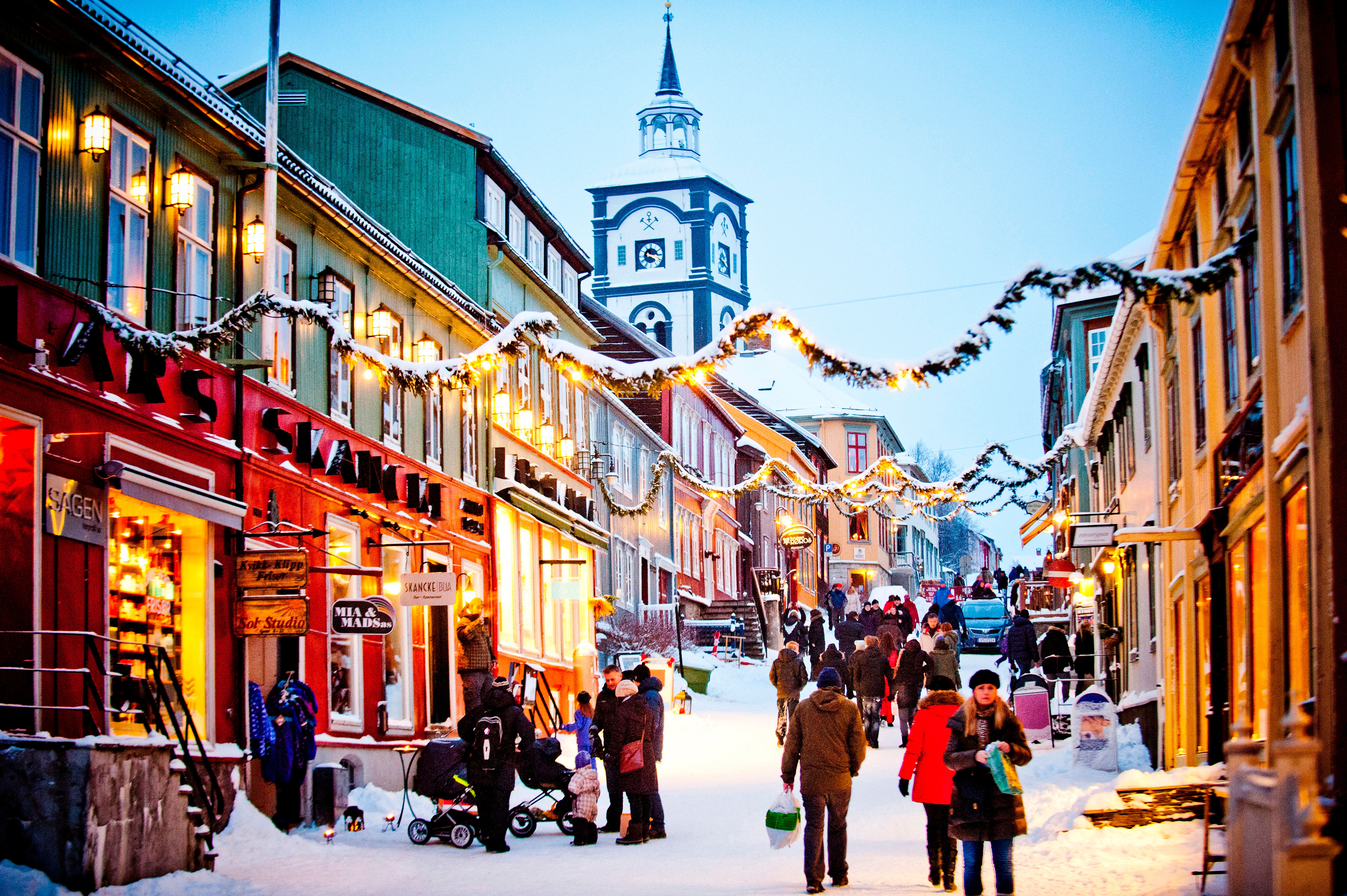 People walking in the snowy street during a Christmas market in Røros in Trøndelag, Norway