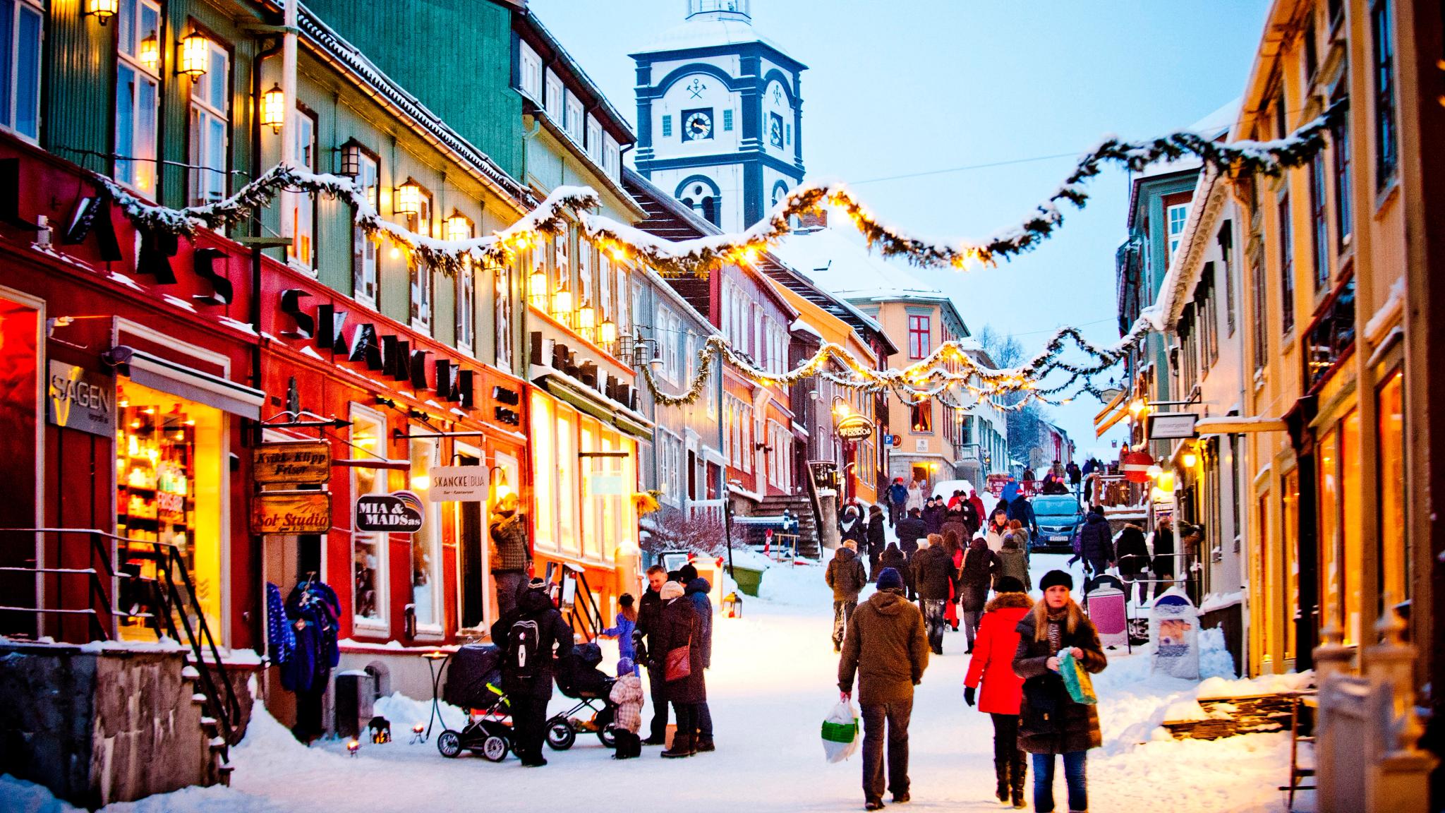 People walking in the snowy street during a Christmas market in Røros in Trøndelag, Norway