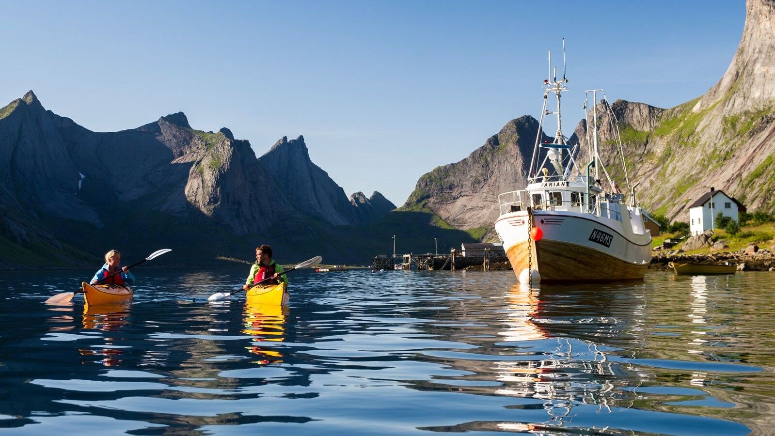 Two people kayaking in Reinefjorden