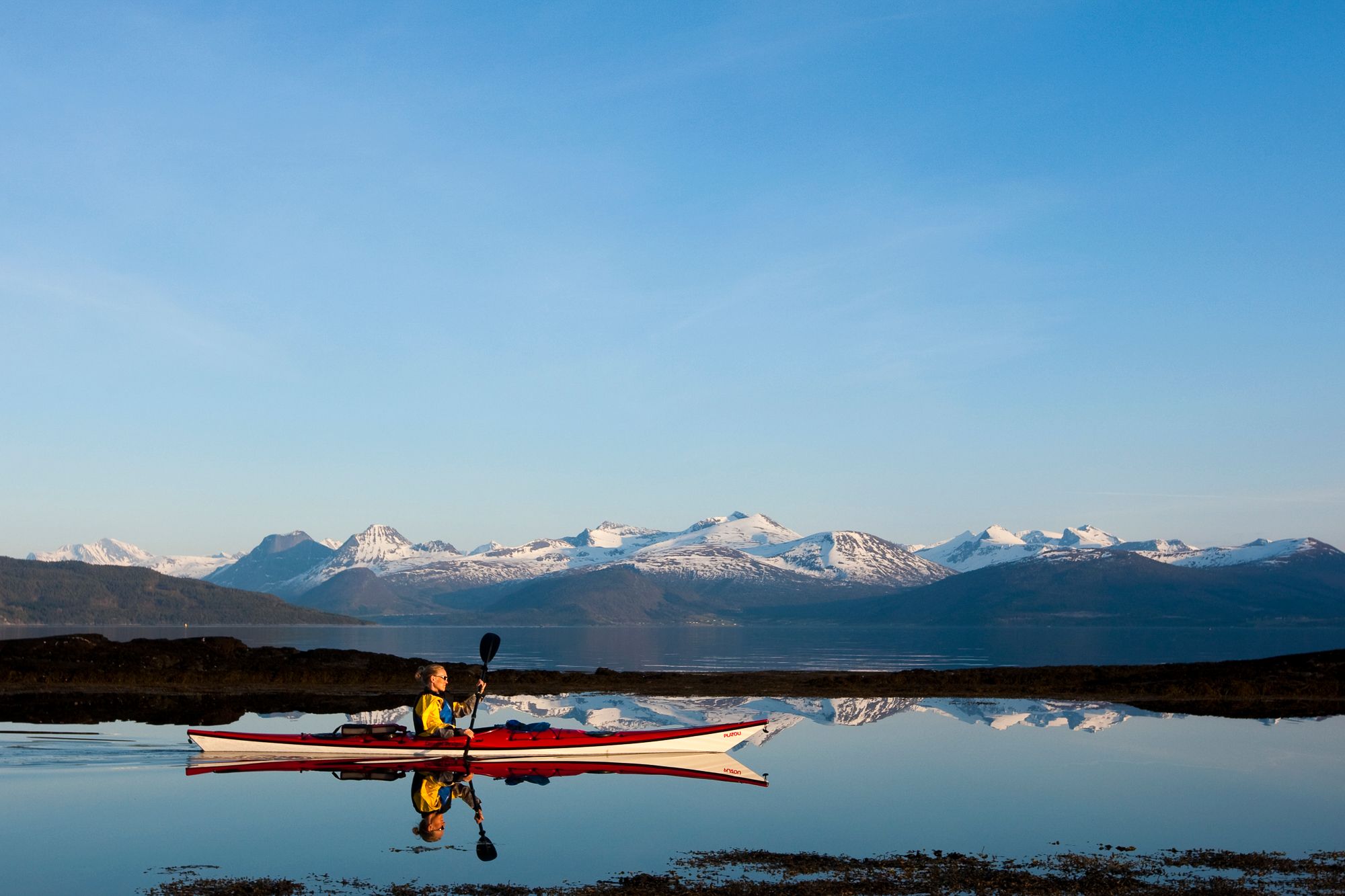A man paddeling a kayak in Molde
