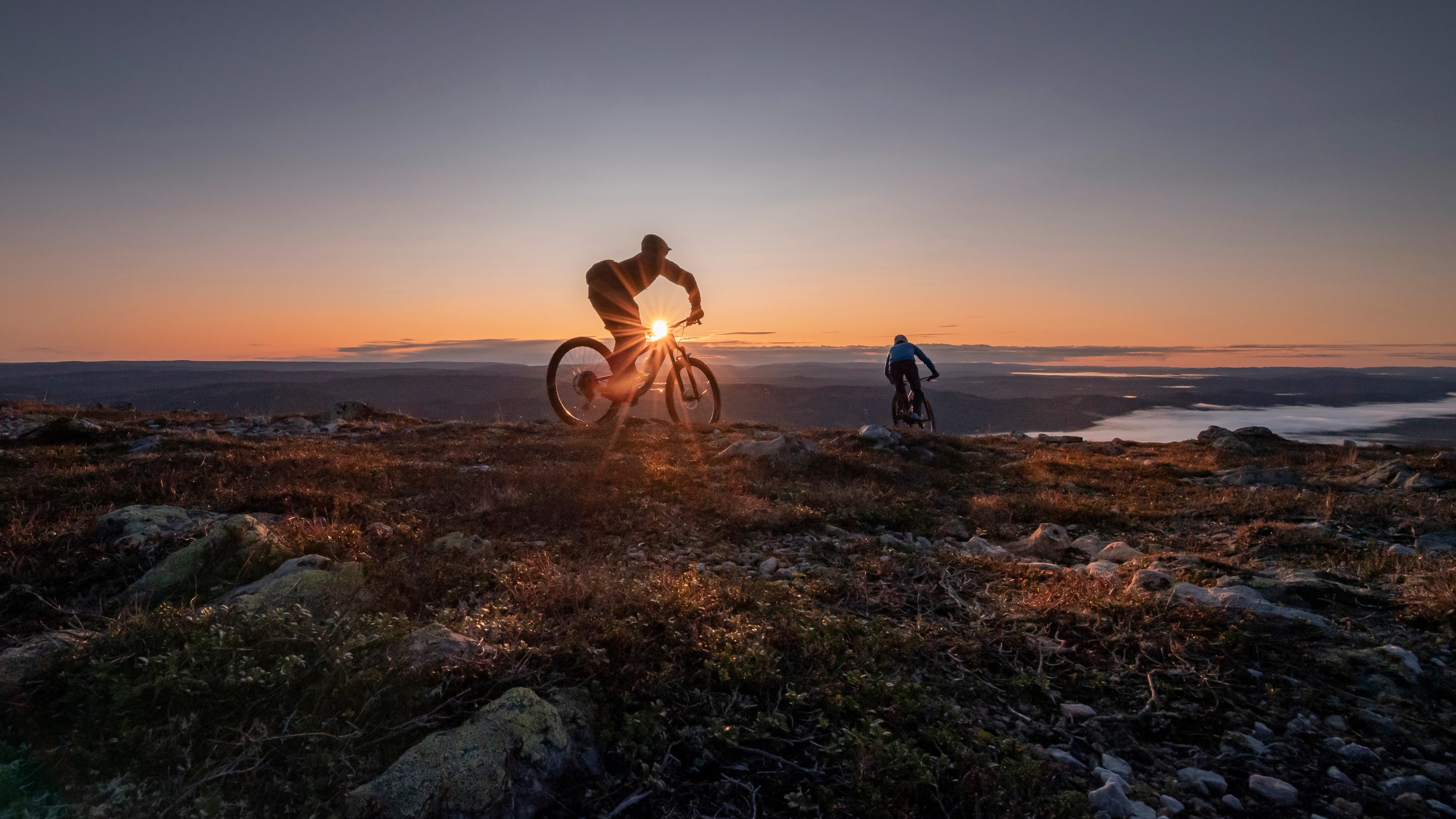 Two people biking in sunset in Trysil