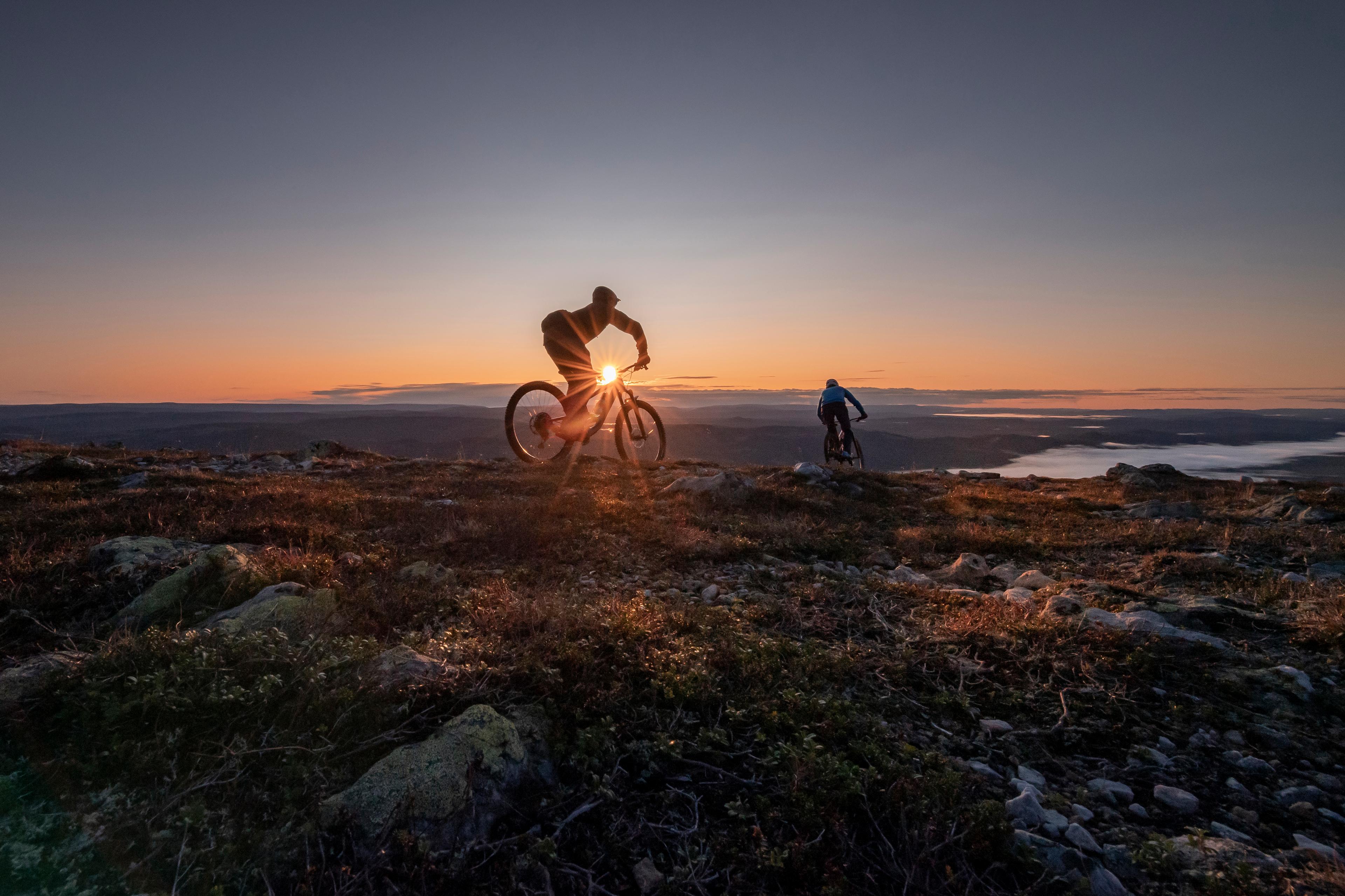Two people biking in sunset in Trysil