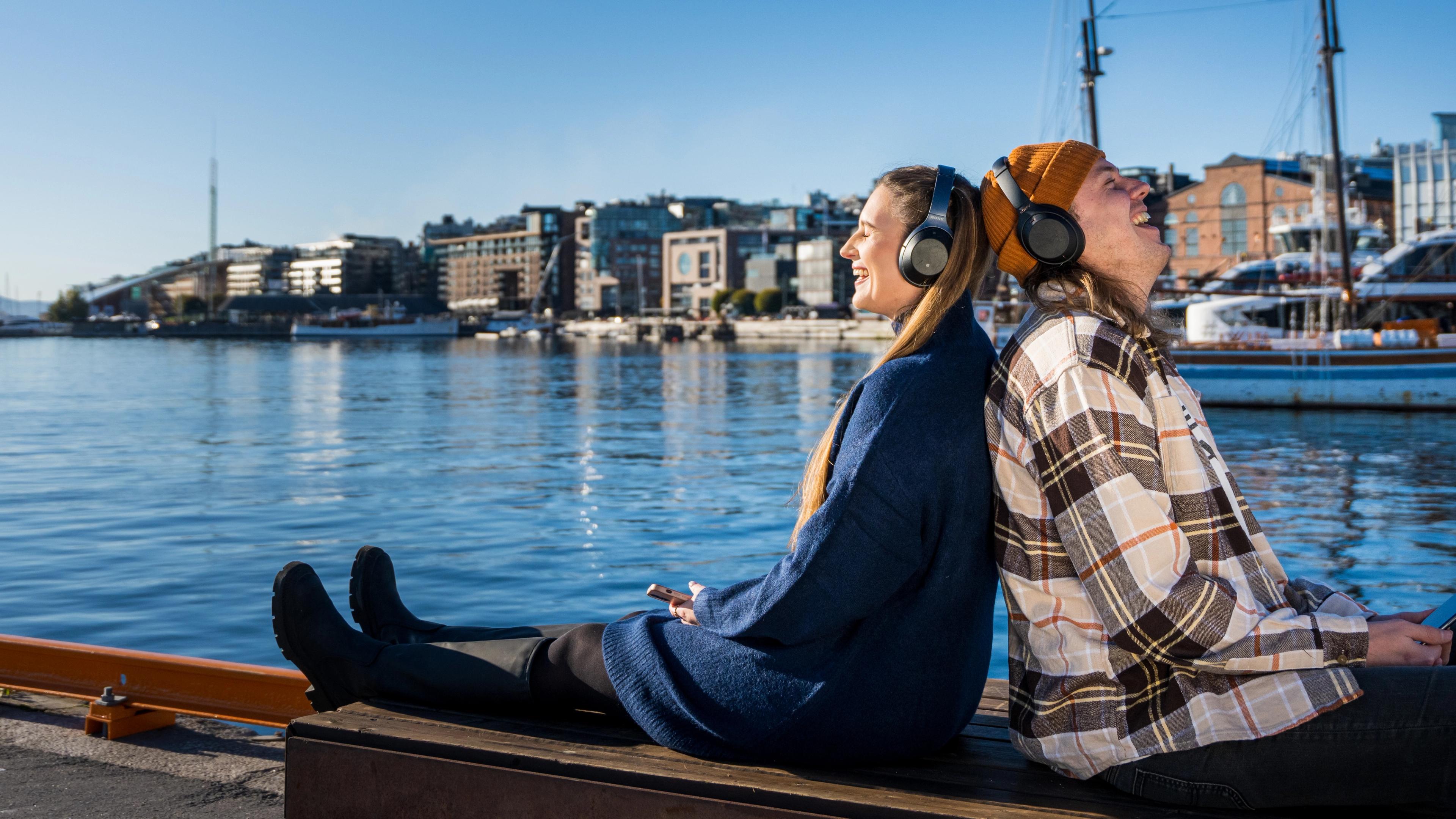 To friends enjoying a good podcast by the fjord, Oslo, Eastern Norway.