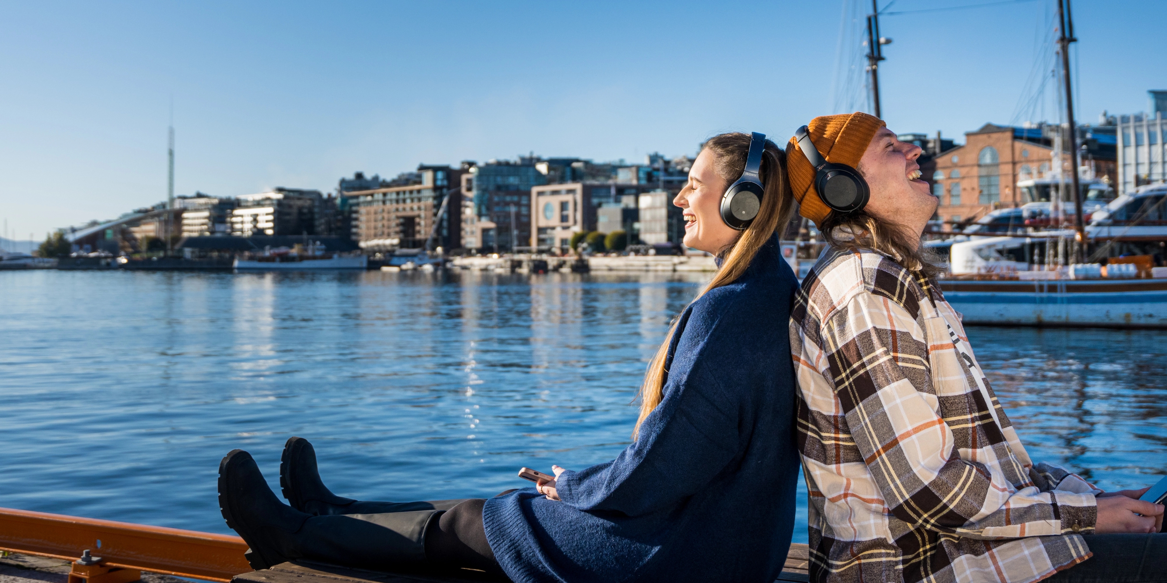 To friends enjoying a good podcast by the fjord, Oslo, Eastern Norway.