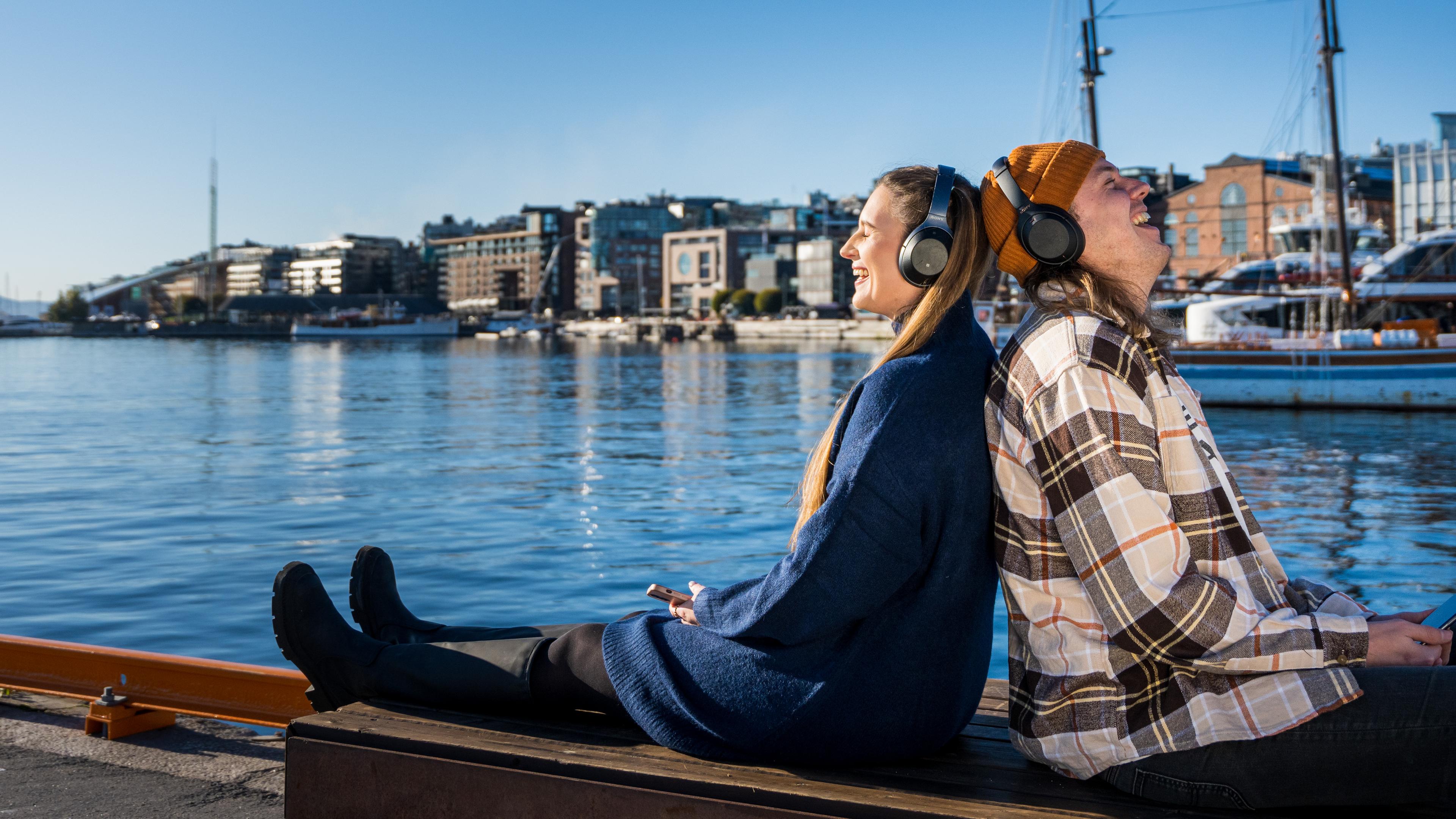 To friends enjoying a good podcast by the fjord, Oslo, Eastern Norway.