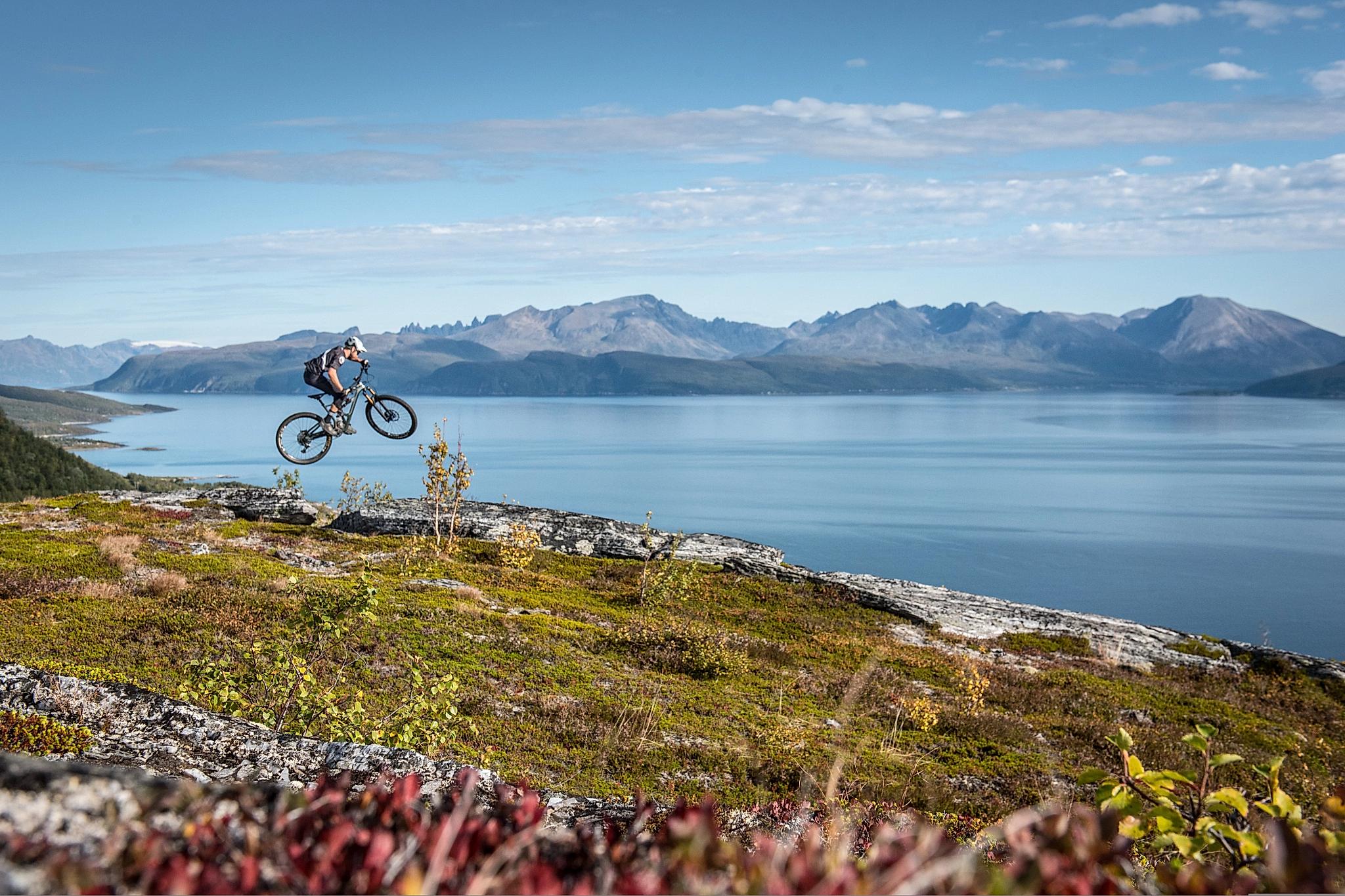 Saut en VTT dans les montagnes de la région du Lyngenfjord, en Norvège du Nord