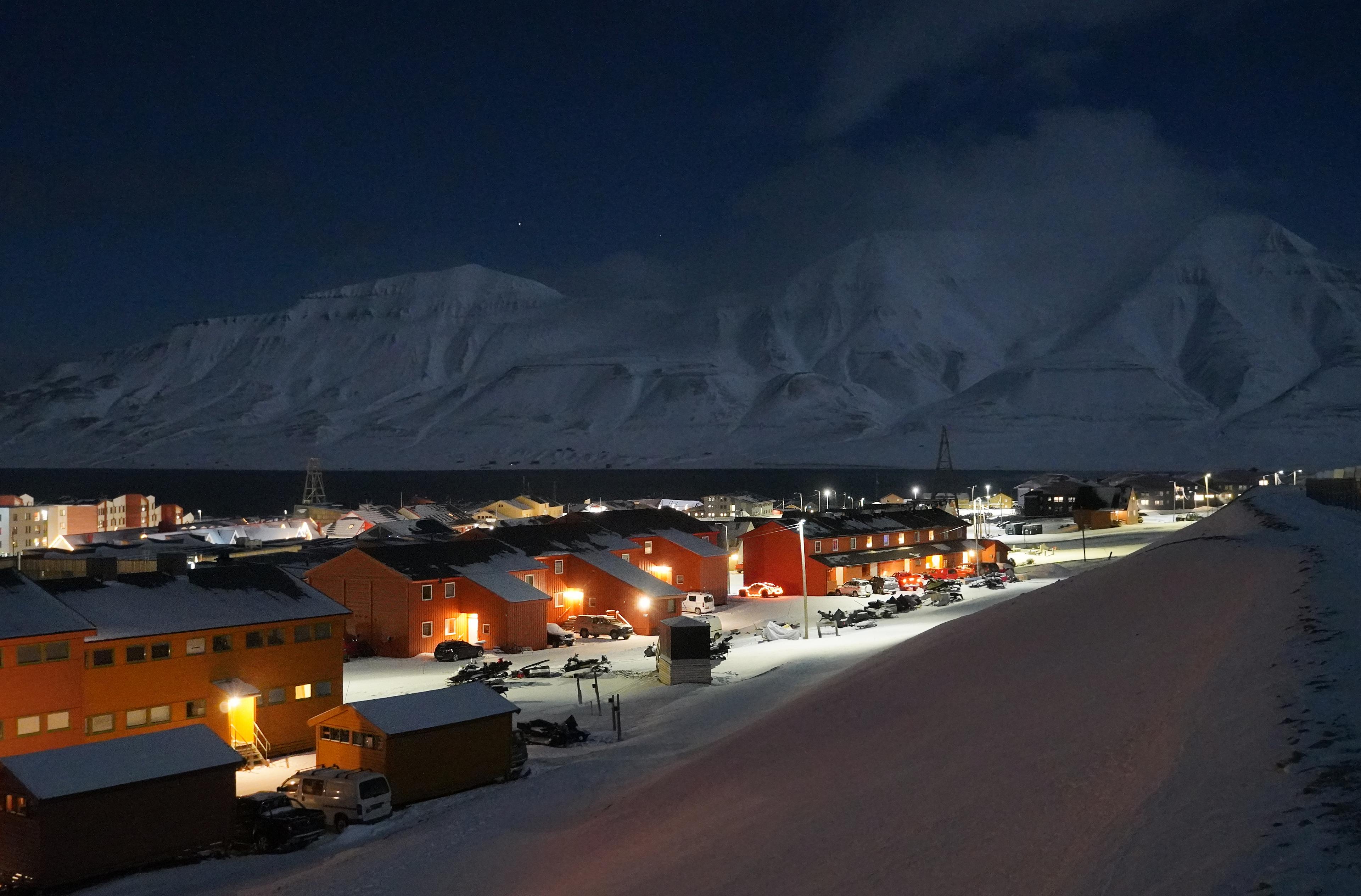 Red houses and white mountains in the polar night