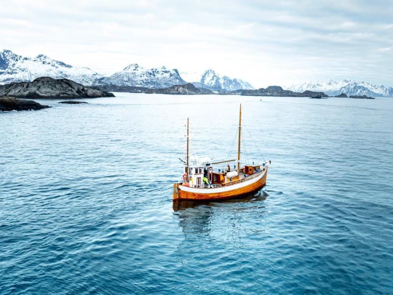 An old fishingboat out at sea in Lofoten