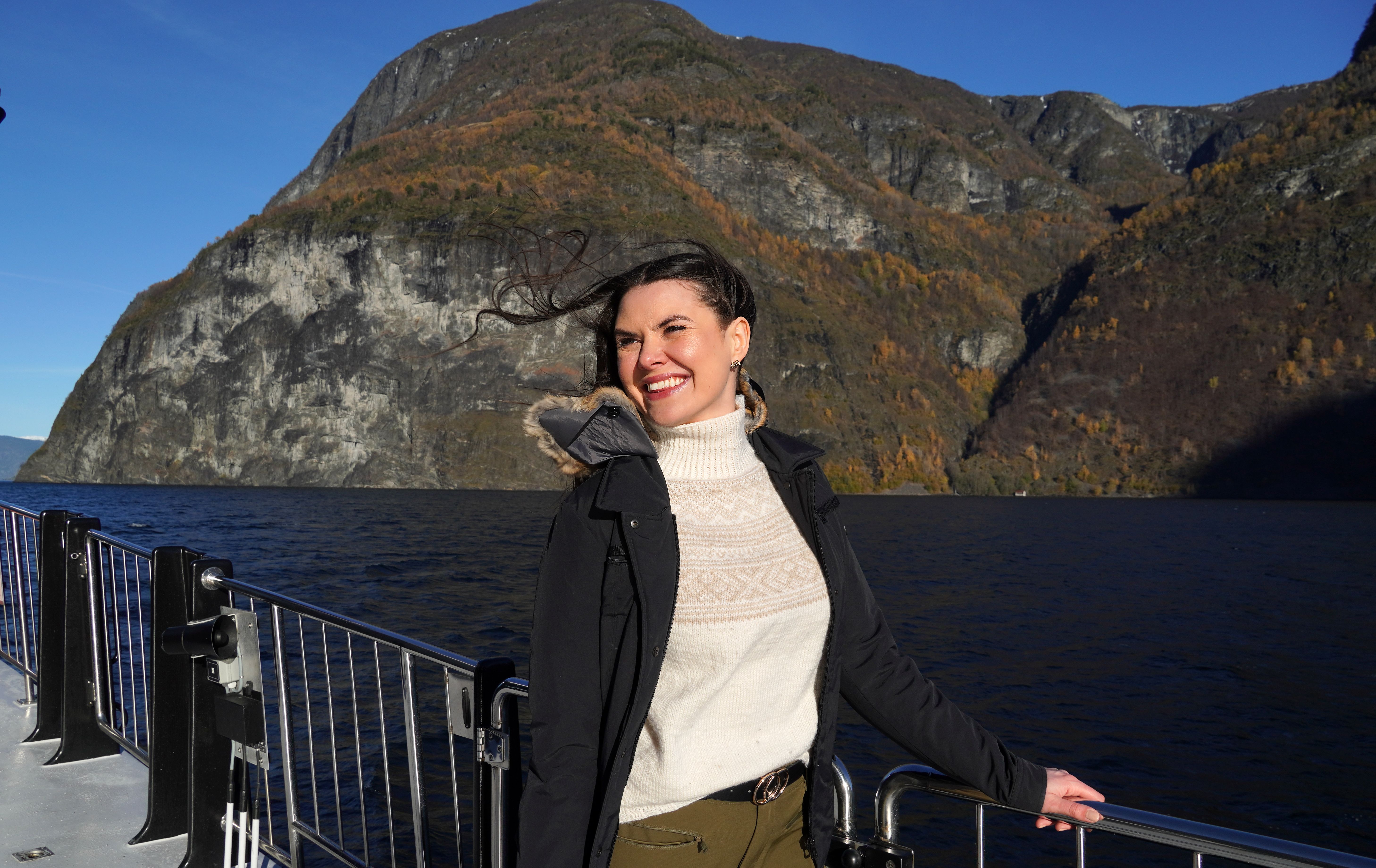 Woman on a cruise in a fjord.