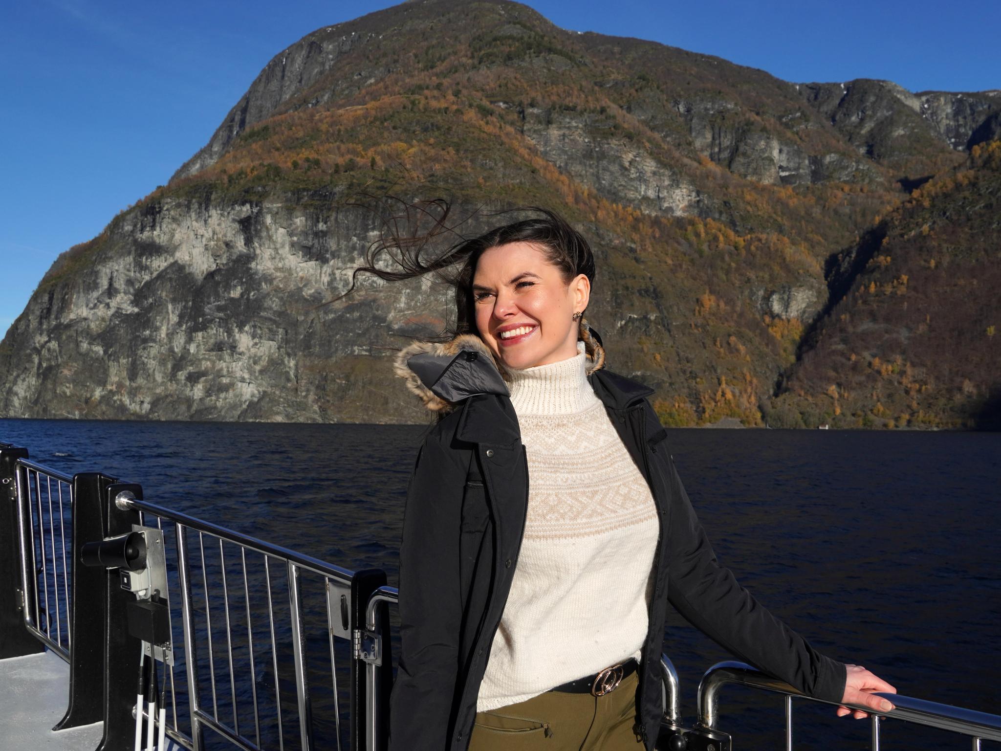 Woman on a cruise in a fjord.