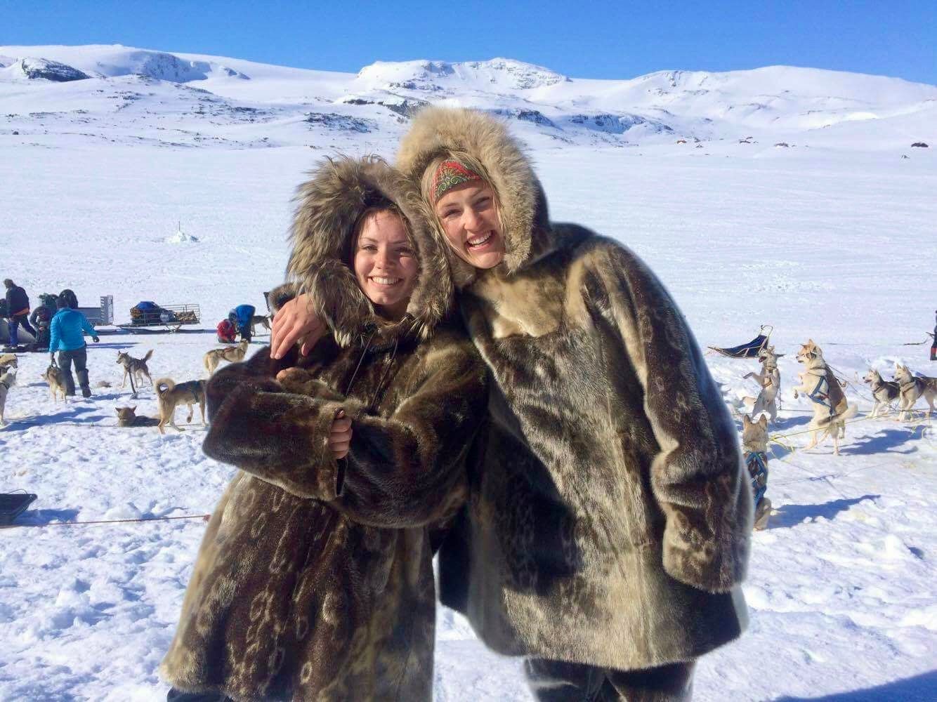 Two women are ready for sled dog racing in the snowy landscape at Finse