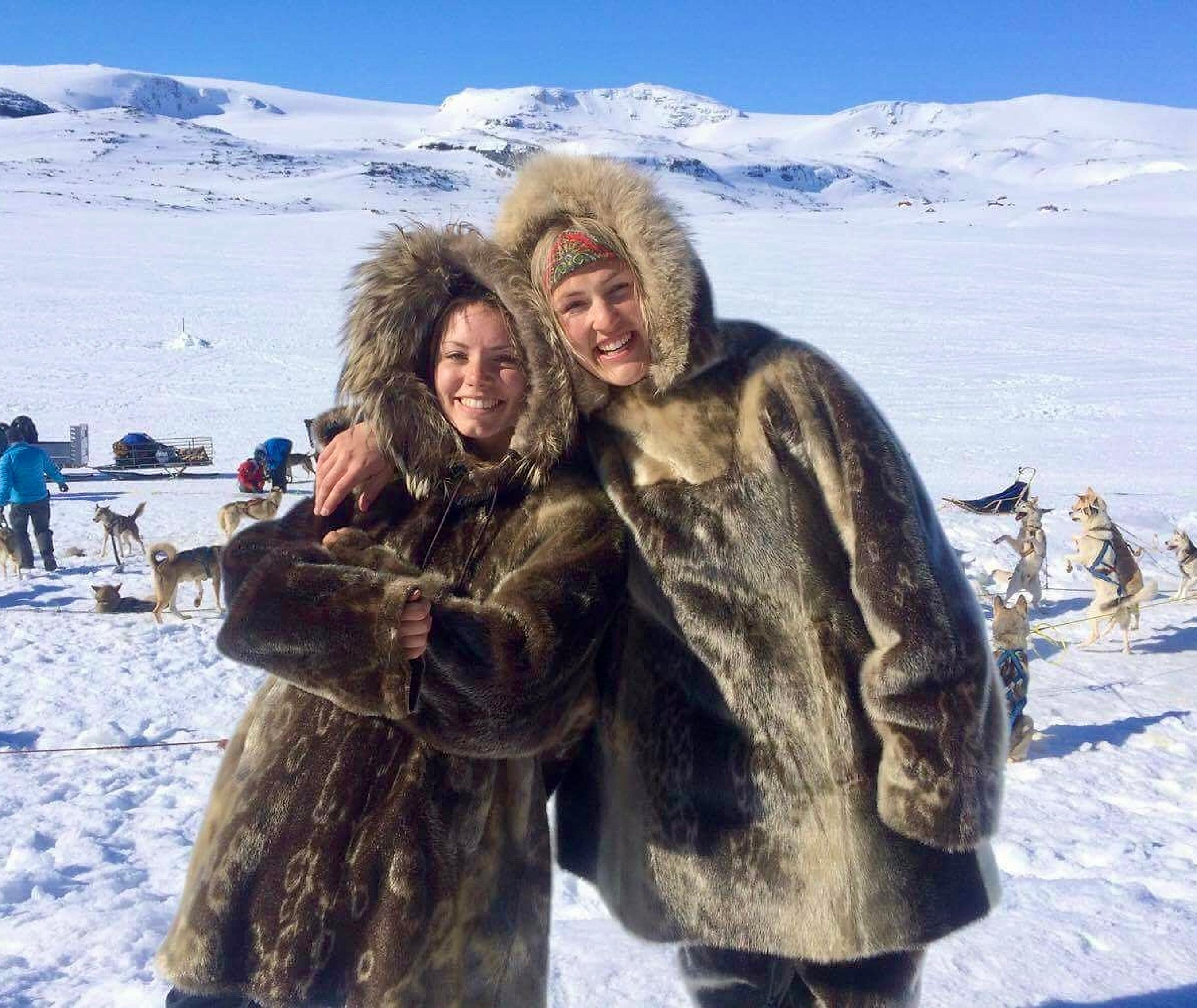 Two women are ready for sled dog racing in the snowy landscape at Finse