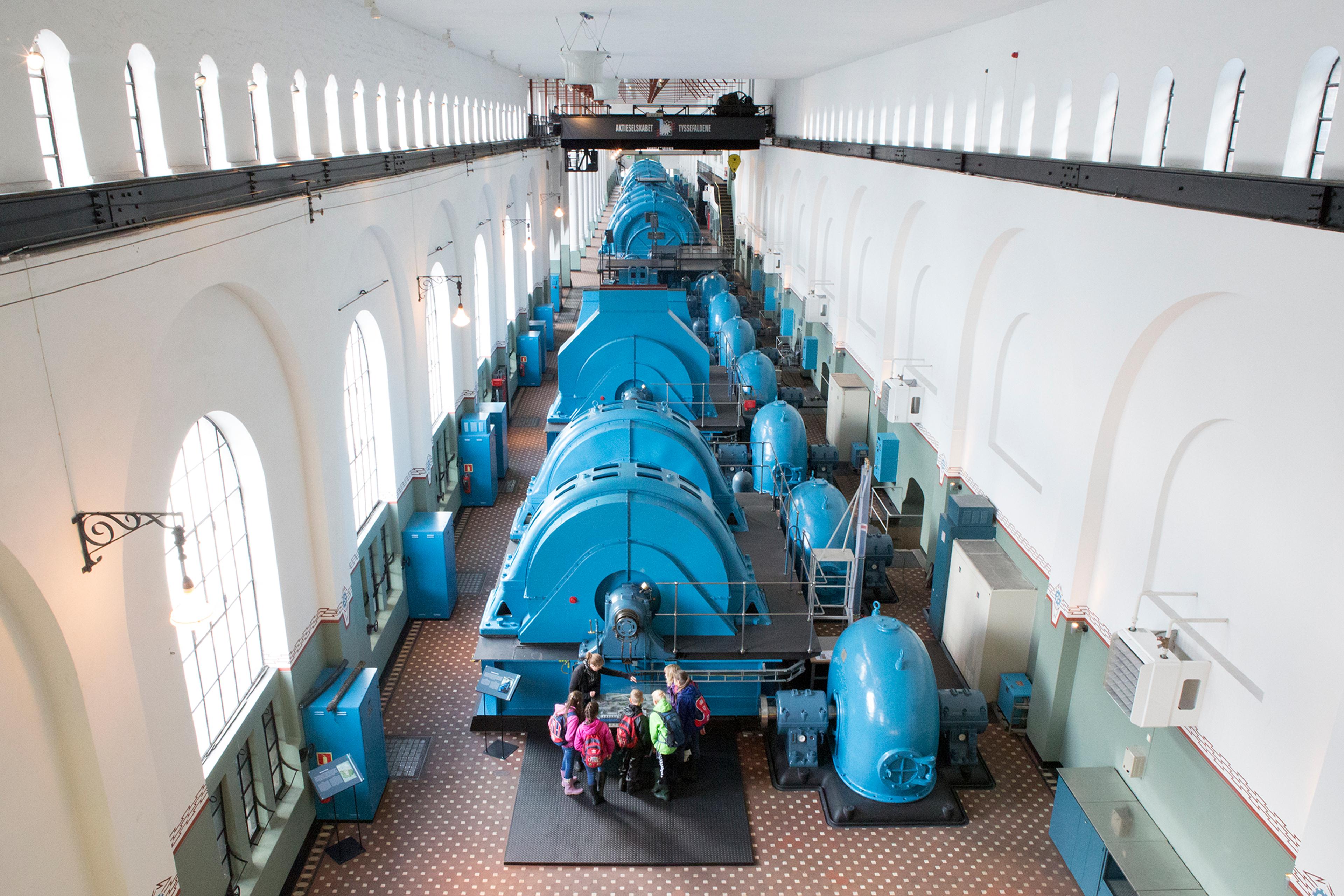 People looking at industrial machines