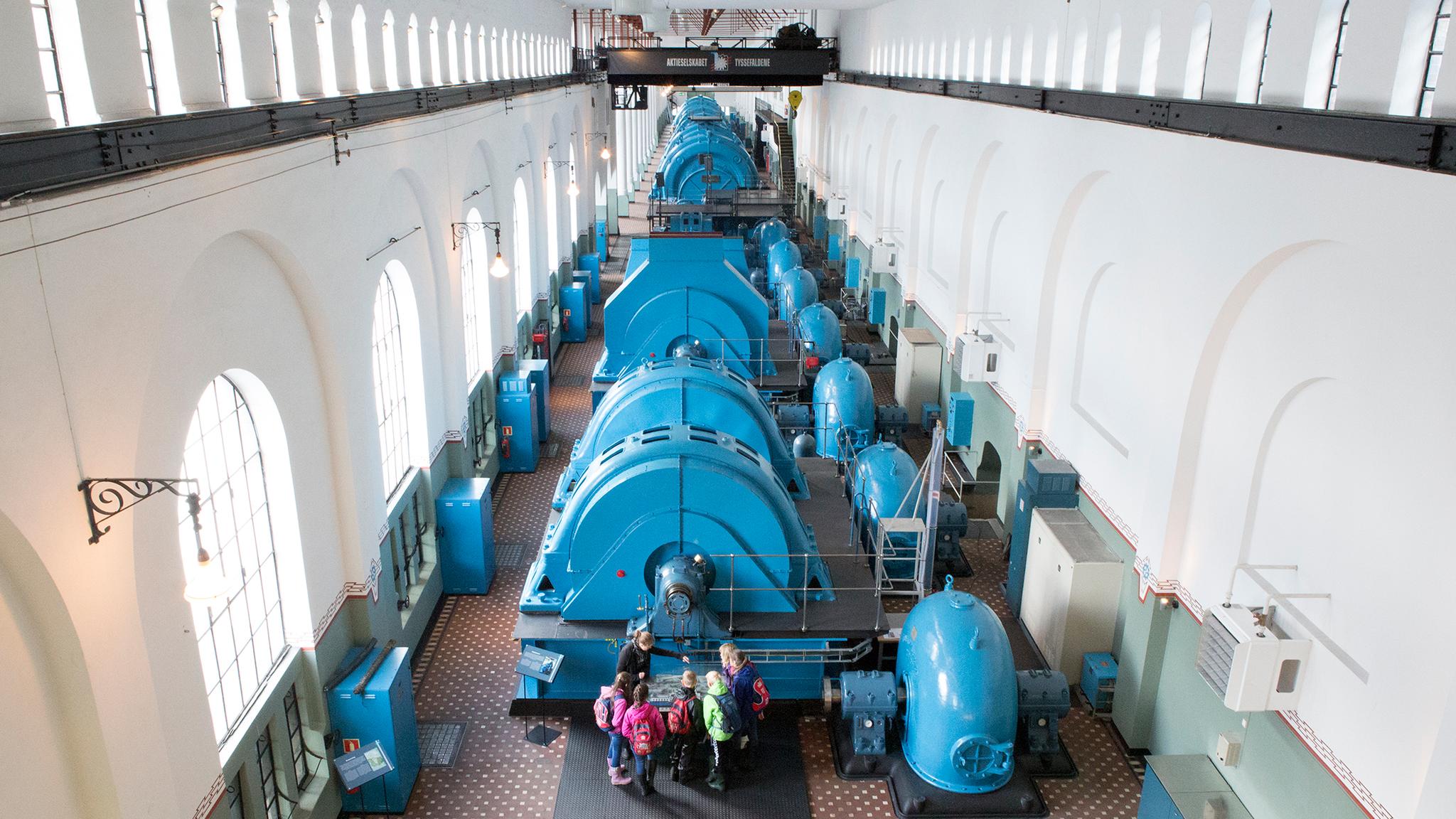 People looking at industrial machines