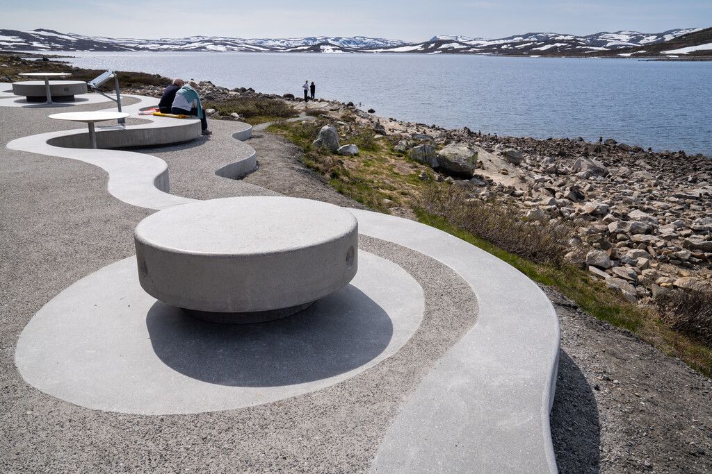 An architecturally built rest area with a view of a lake