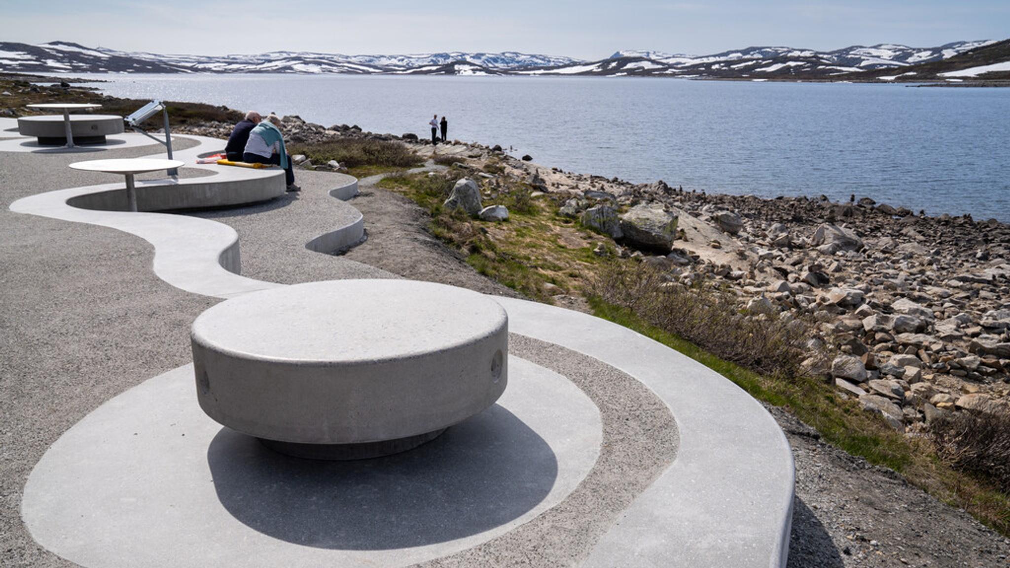 An architecturally built rest area with a view of a lake