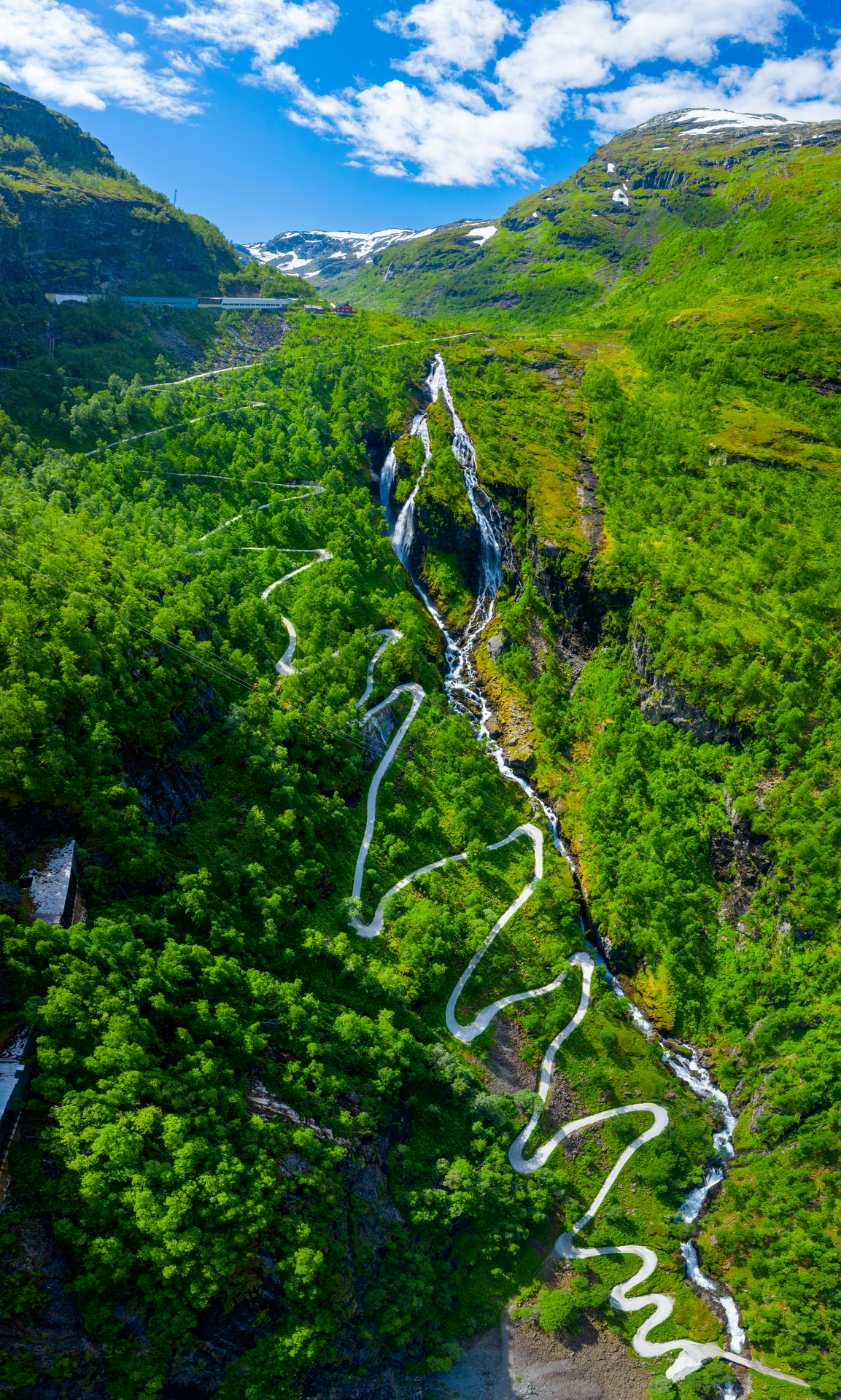 road snaking with steep turns through a lush valley