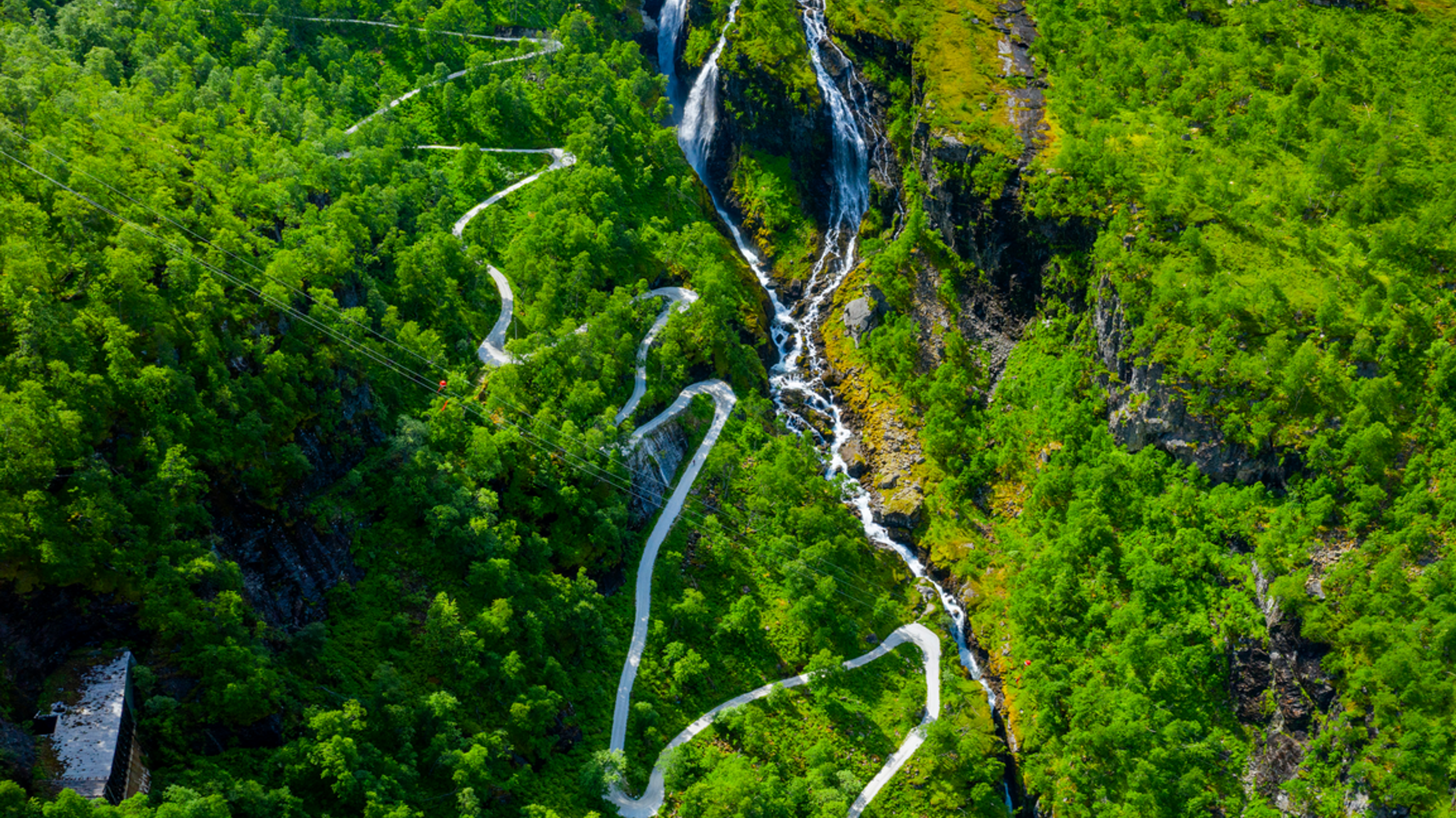 road snaking with steep turns through a lush valley