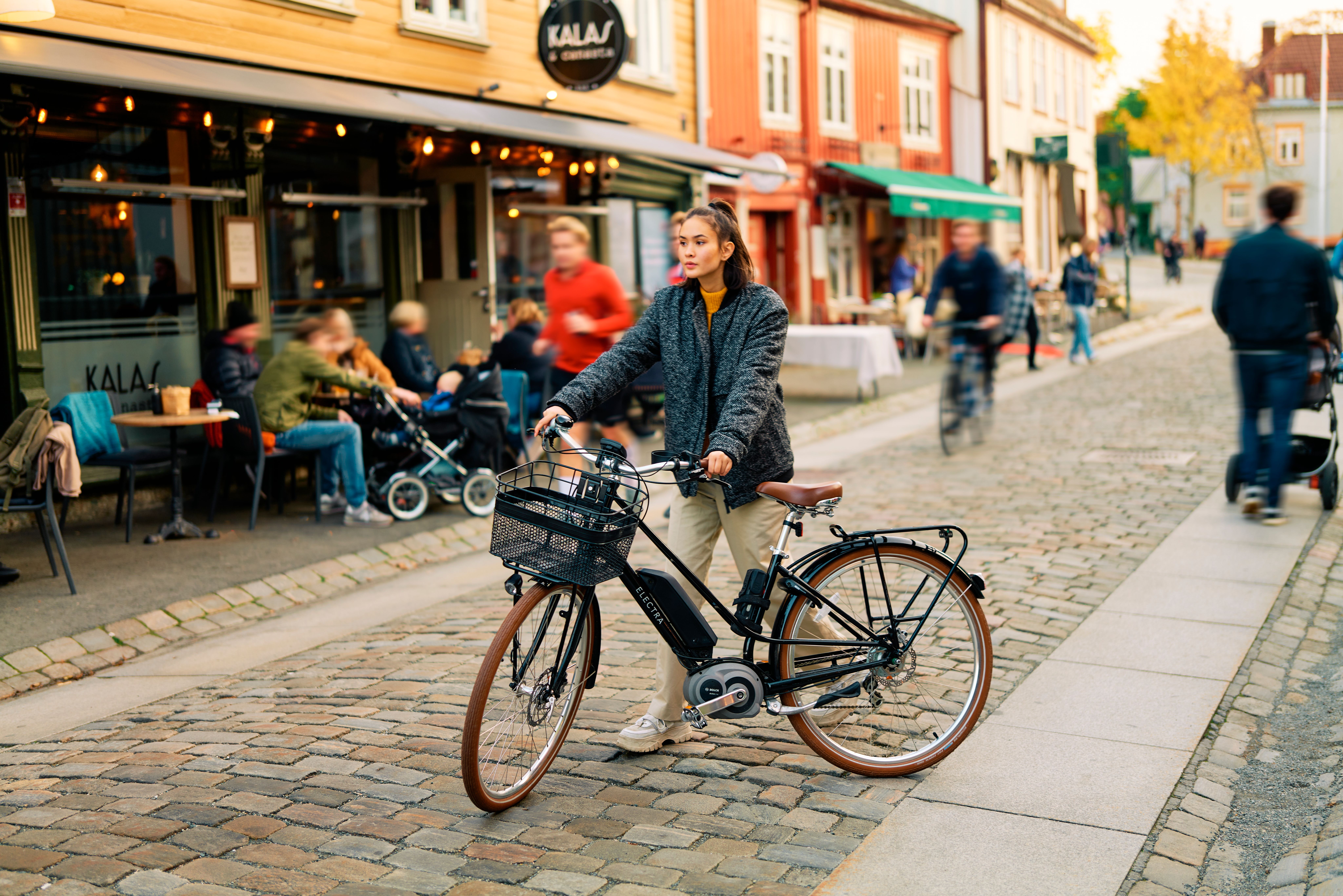 A woman and her bicycle at Bakklandet in Trondheim in the Trøndelag region of Norway