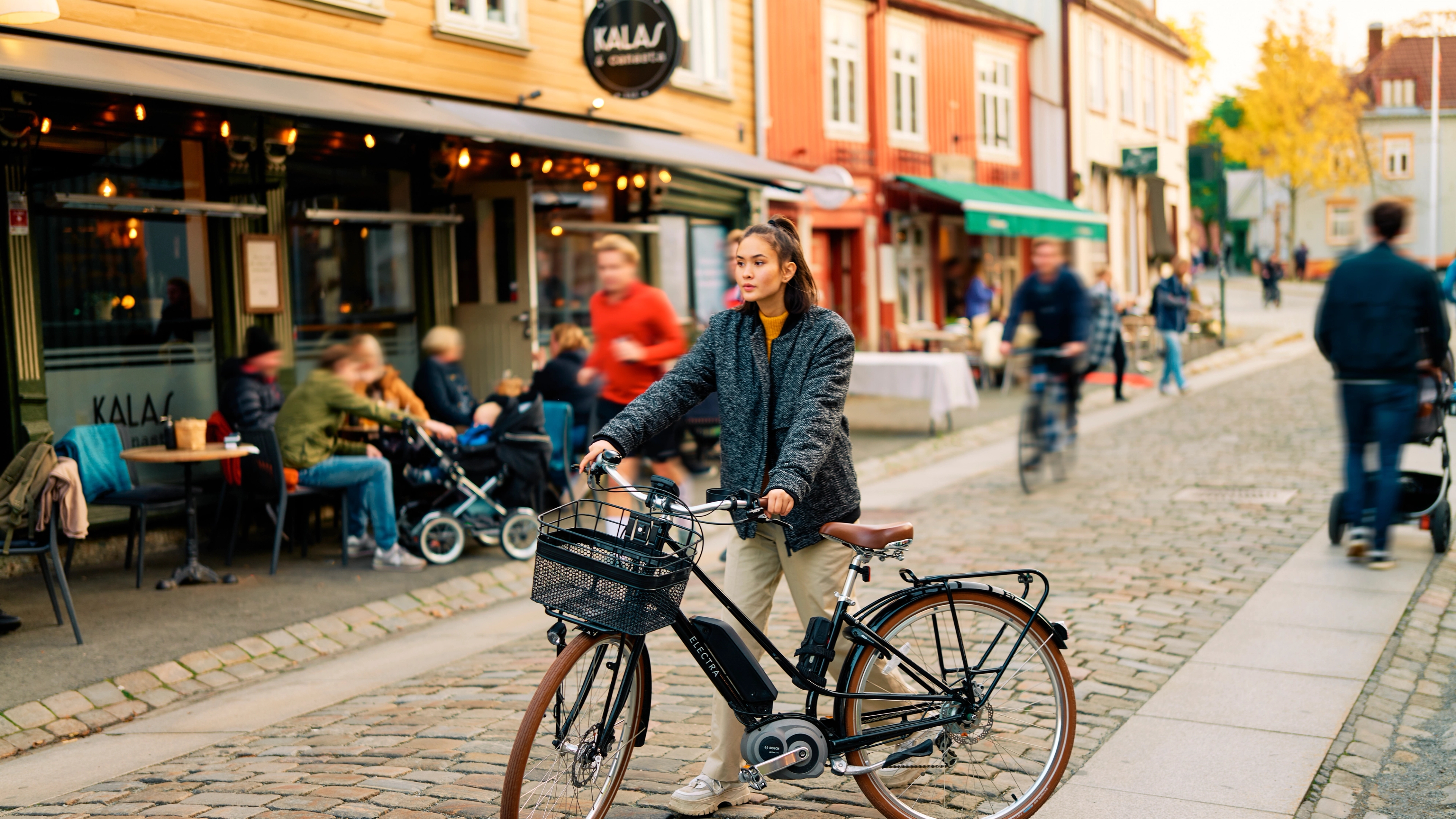 A woman and her bicycle at Bakklandet in Trondheim in the Trøndelag region of Norway