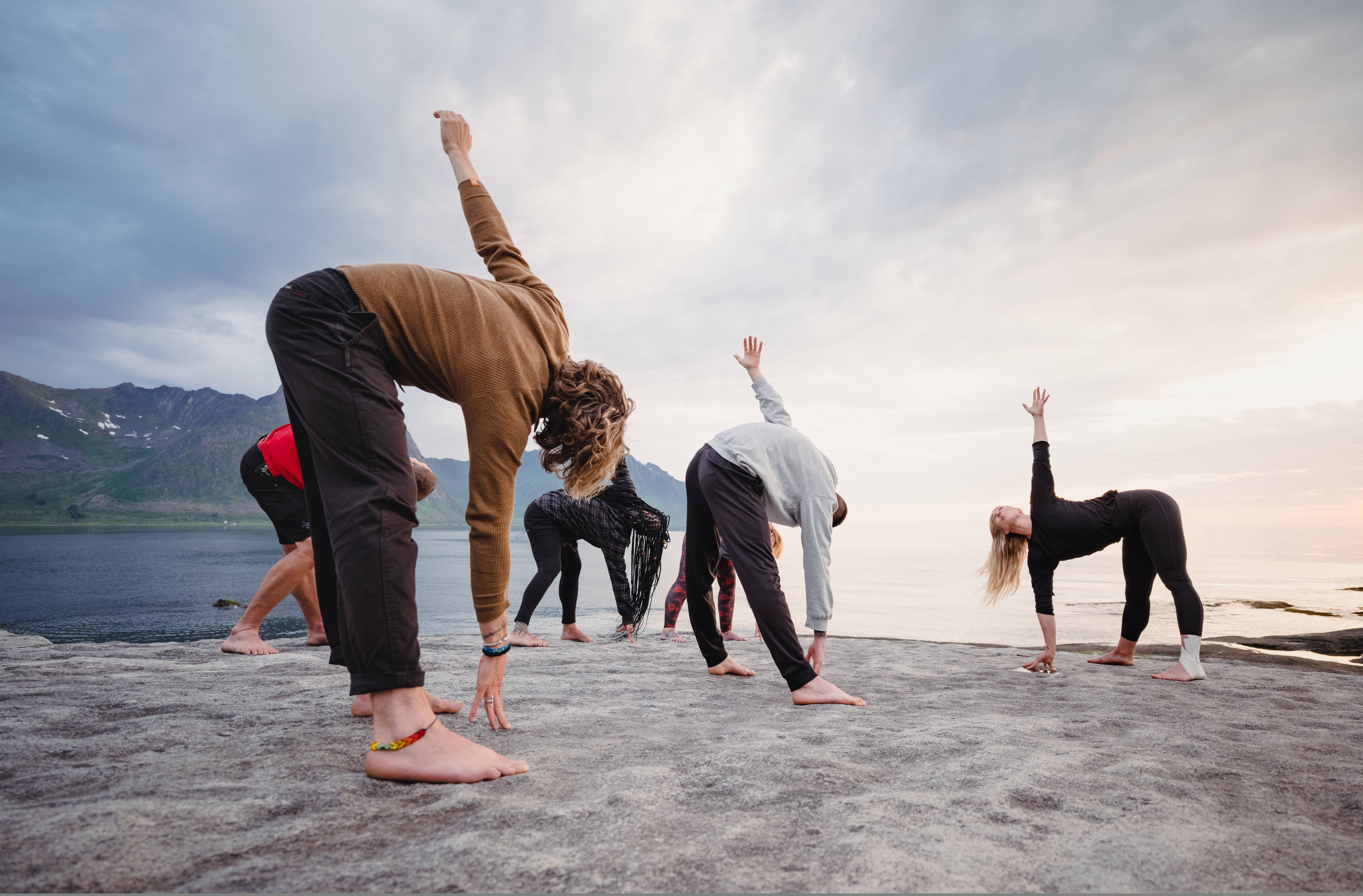 People doing yoga in the nature in Senja, Northern Norway.