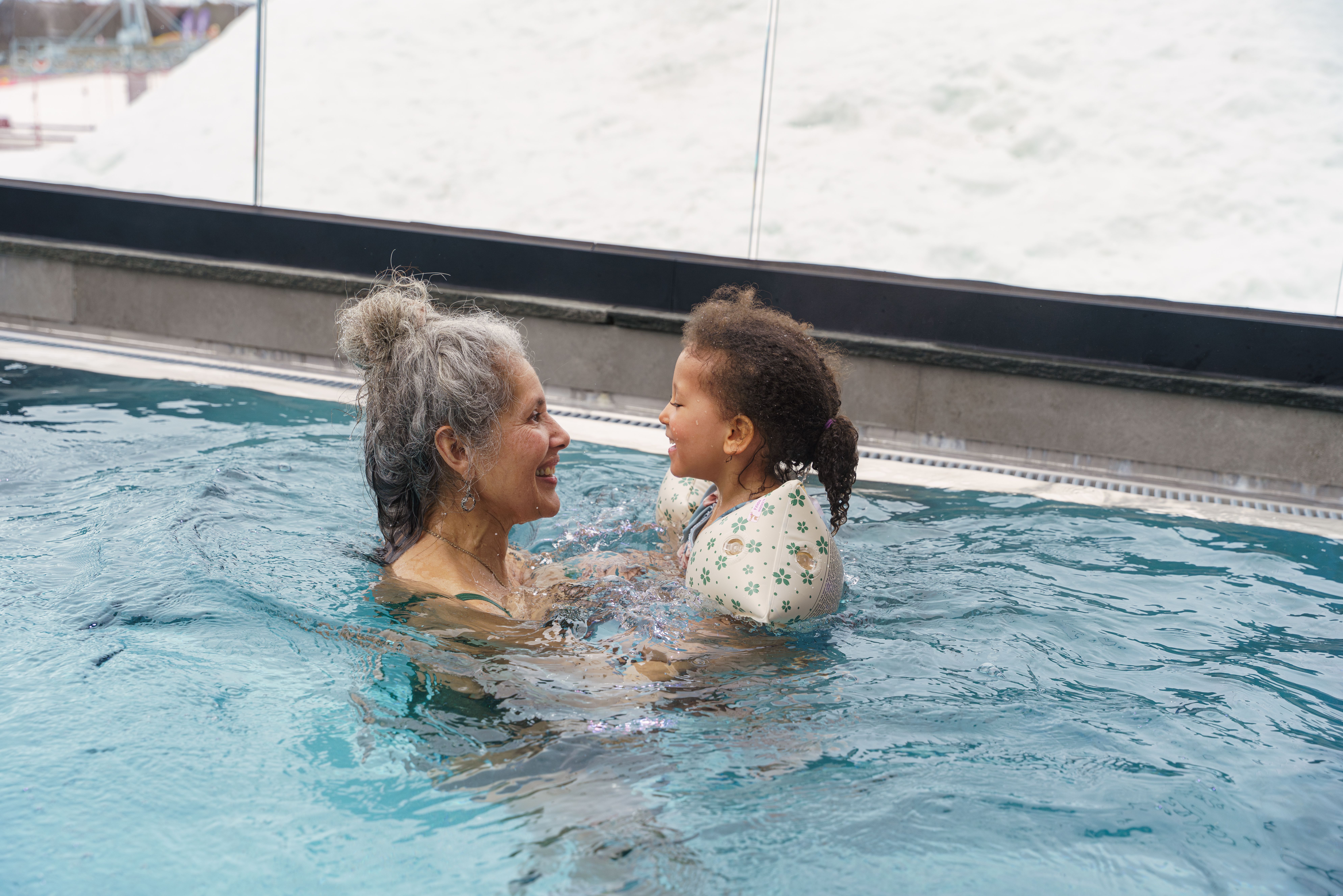 A grandmother and her grandchild swimming at a spa in Beitostølen in Norway
