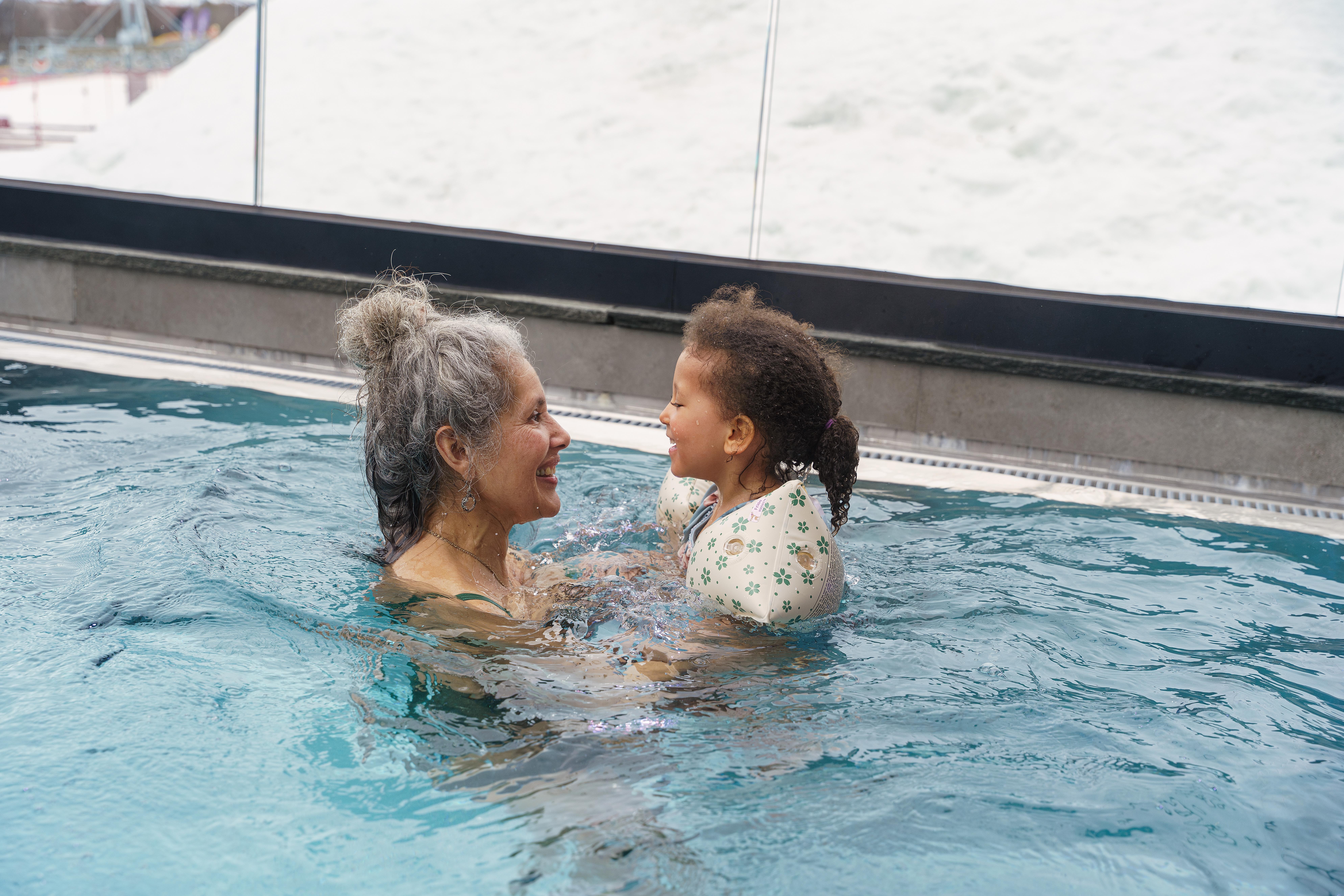 A grandmother and her grandchild swimming at a spa in Beitostølen in Norway