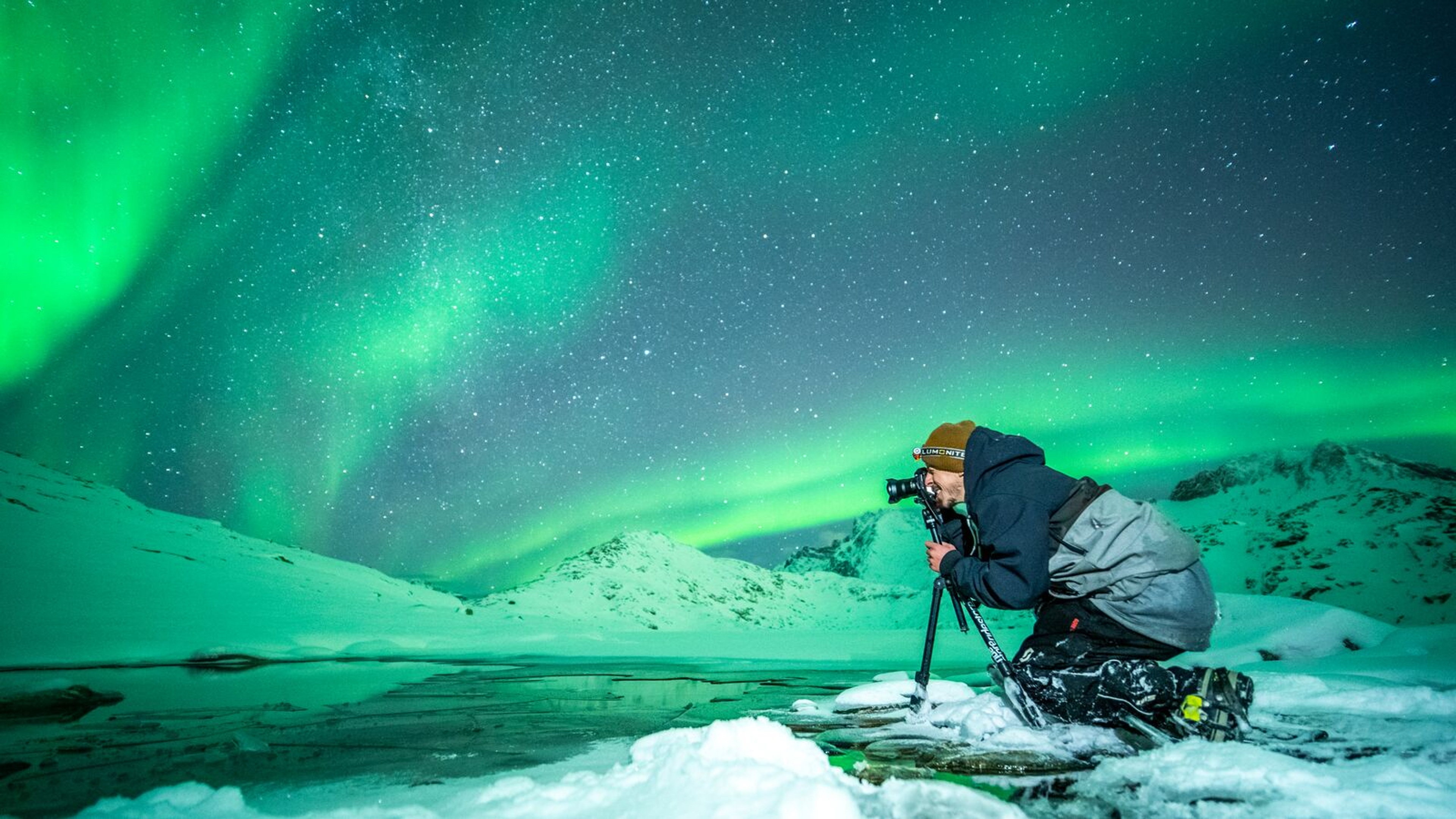 Person taking picture of the northern lights in Northern Norway