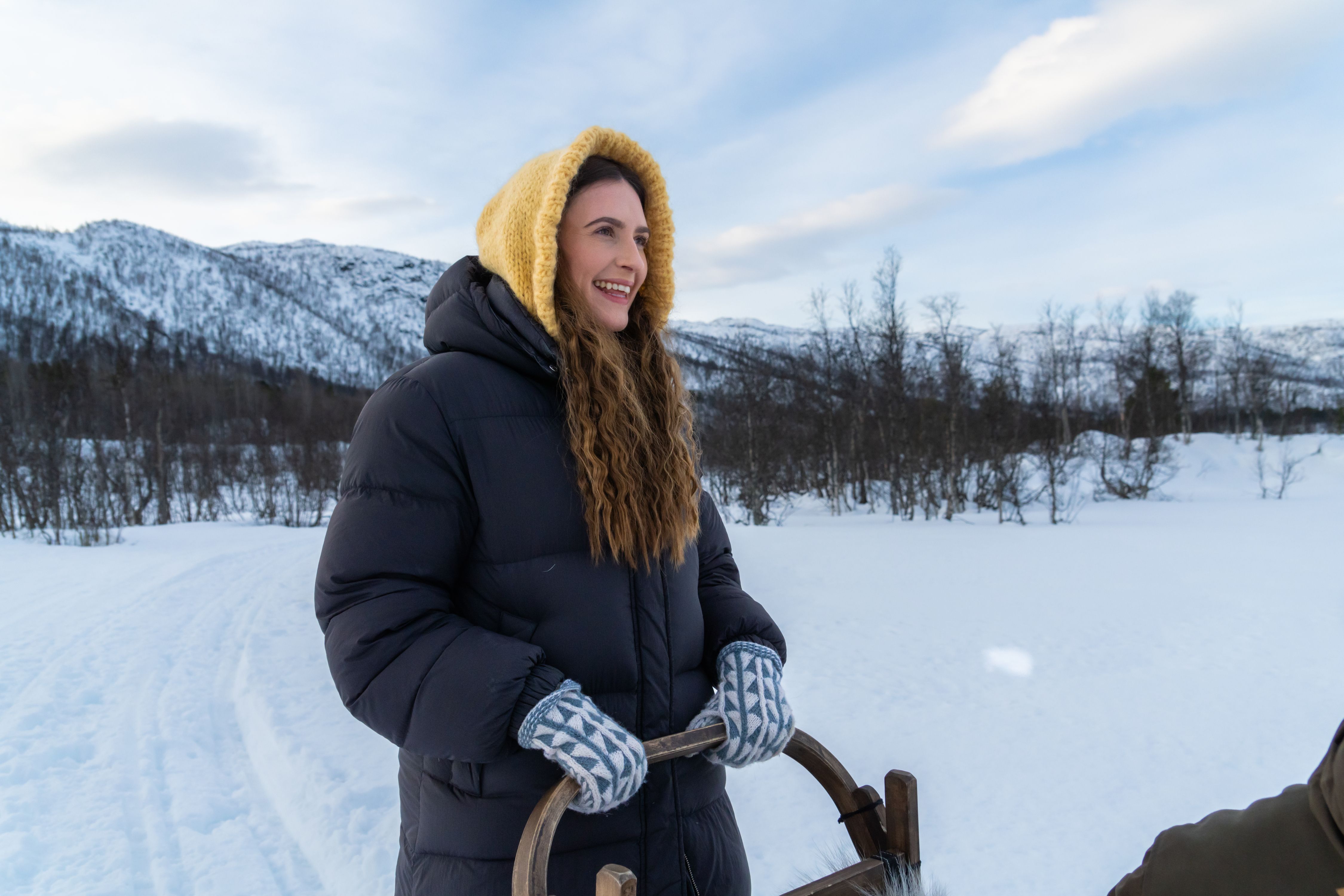 A woman trying to be a musher while going dog sledding at Geilo in the winter.