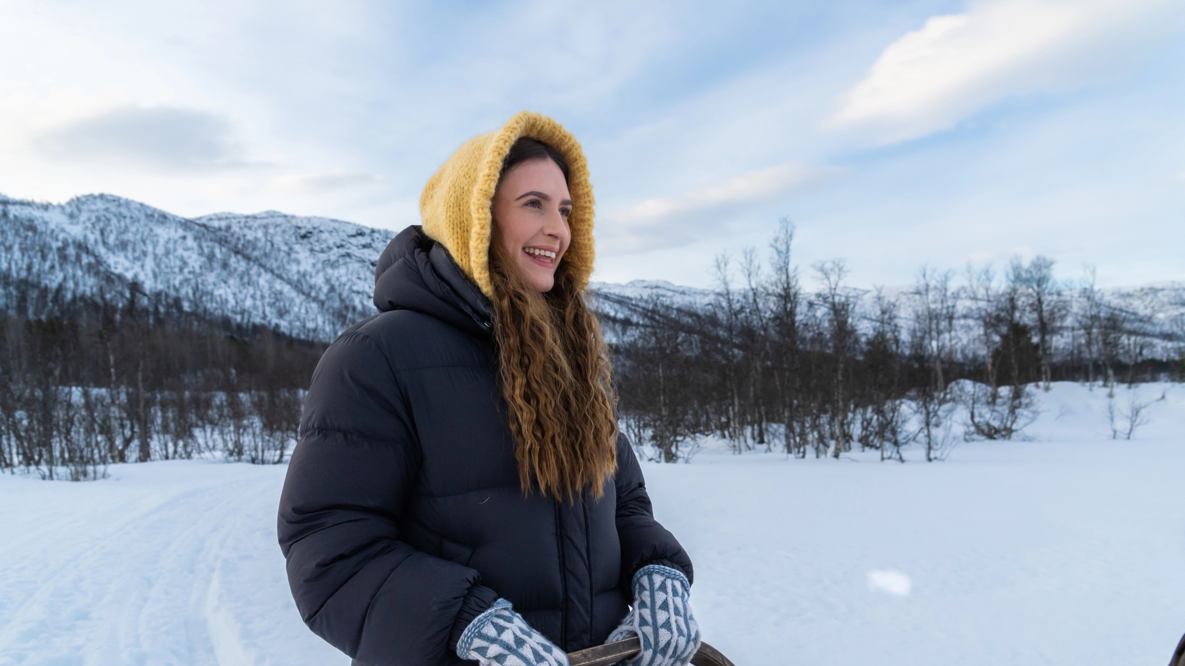 A woman trying to be a musher while going dog sledding at Geilo in the winter.