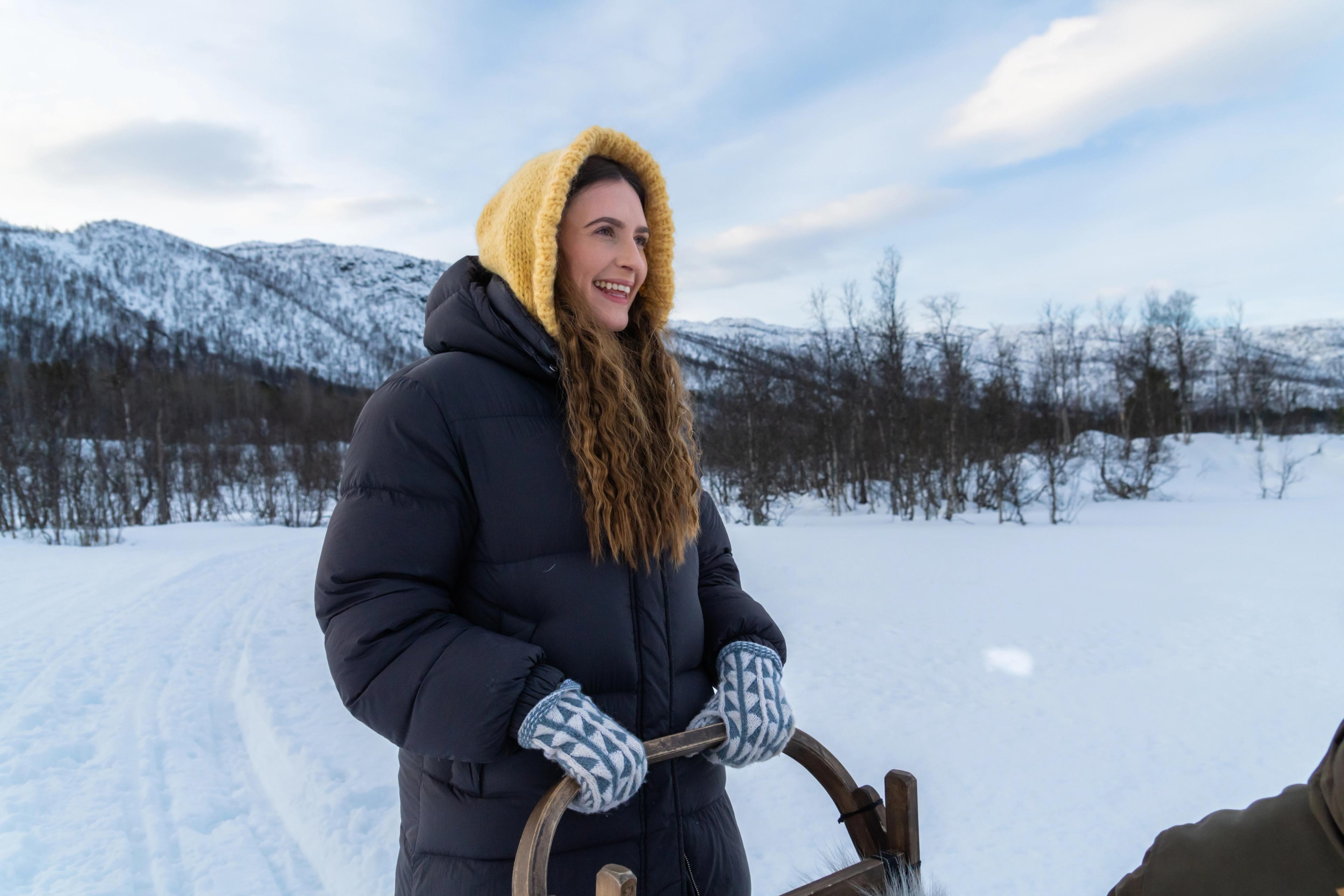 A woman trying to be a musher while going dog sledding at Geilo in the winter.