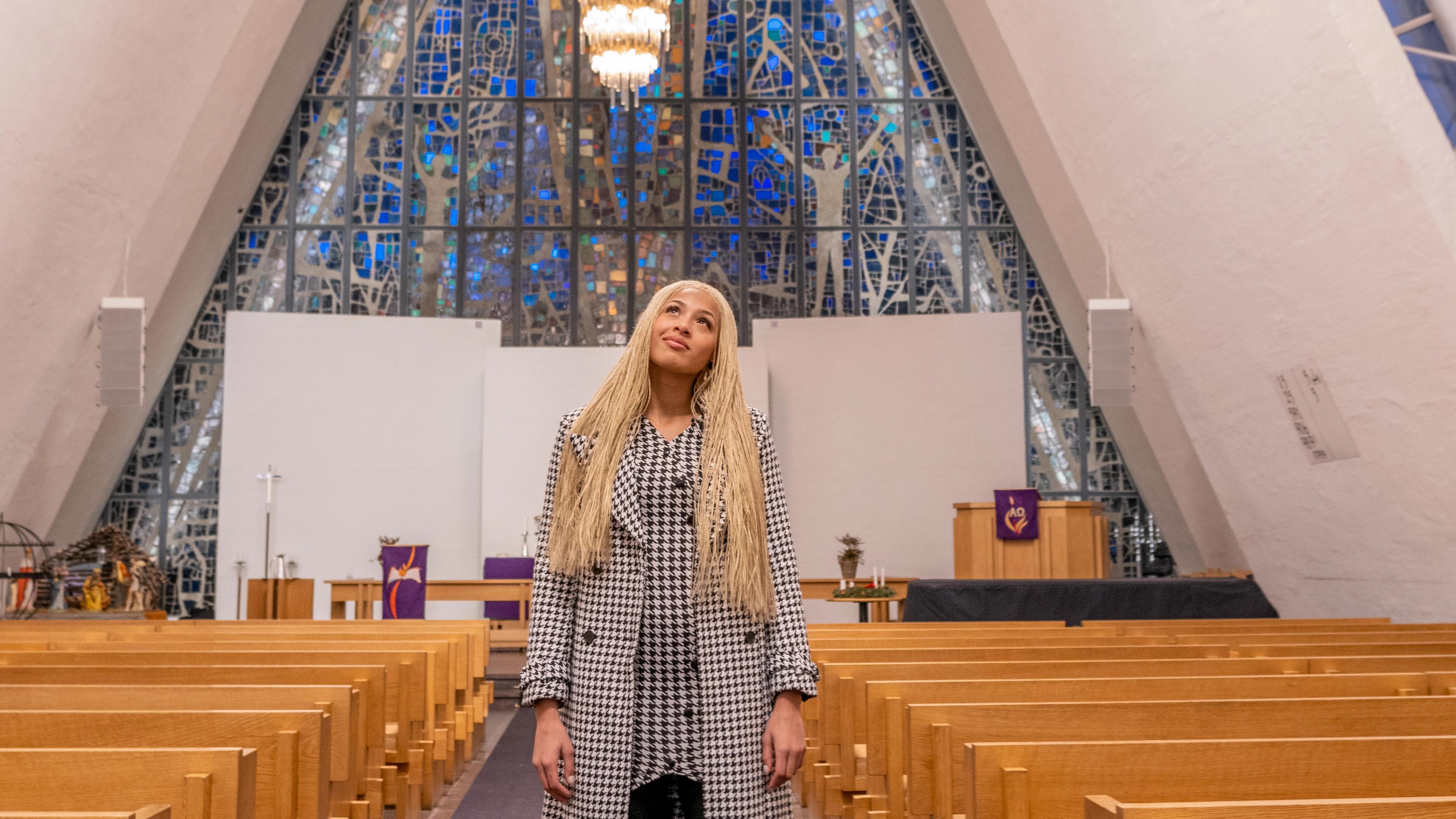Artist Ida Tolou standing in the Arctic Cathedral in Tromsø