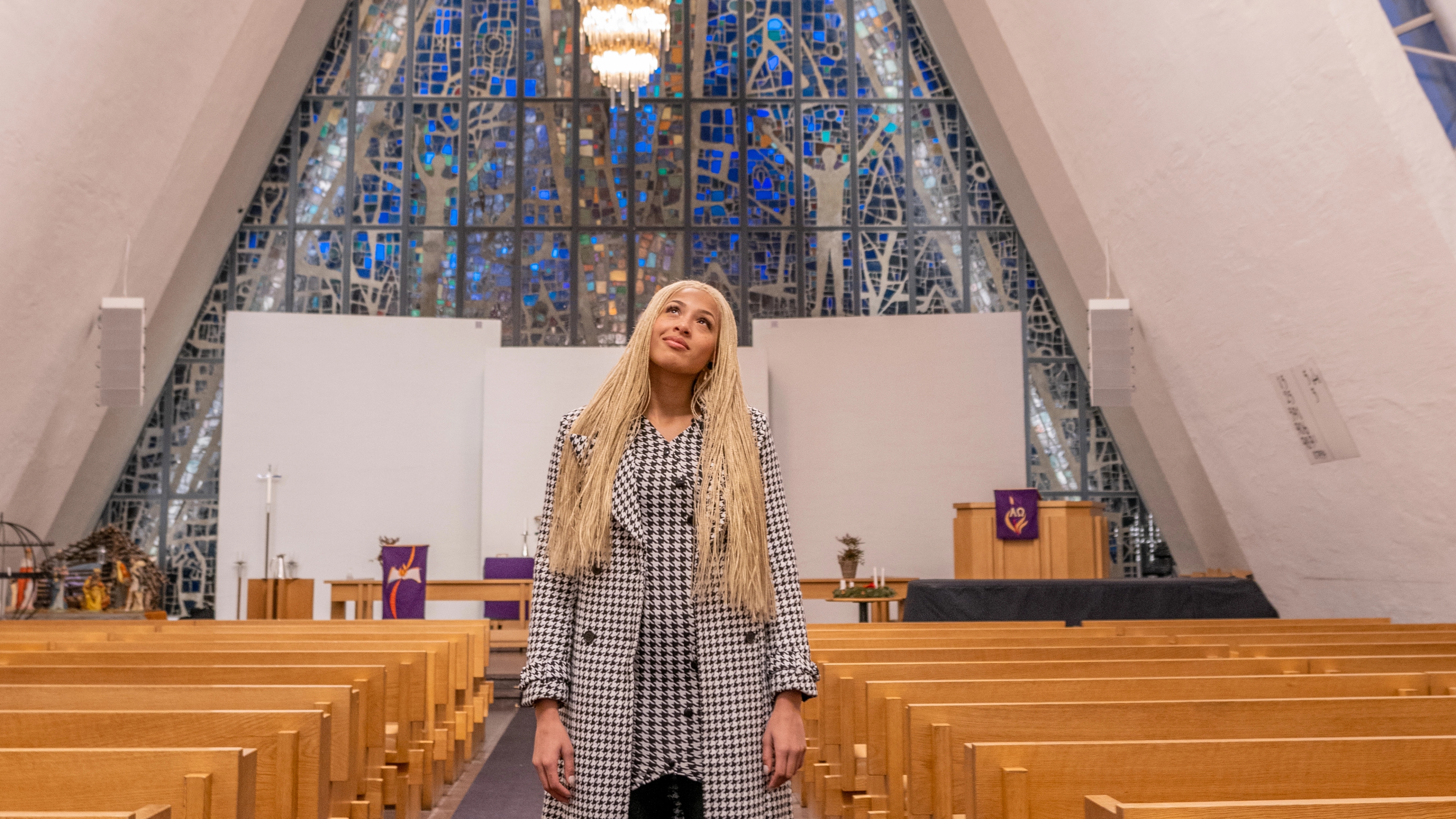 Artist Ida Tolou standing in the Arctic Cathedral in Tromsø