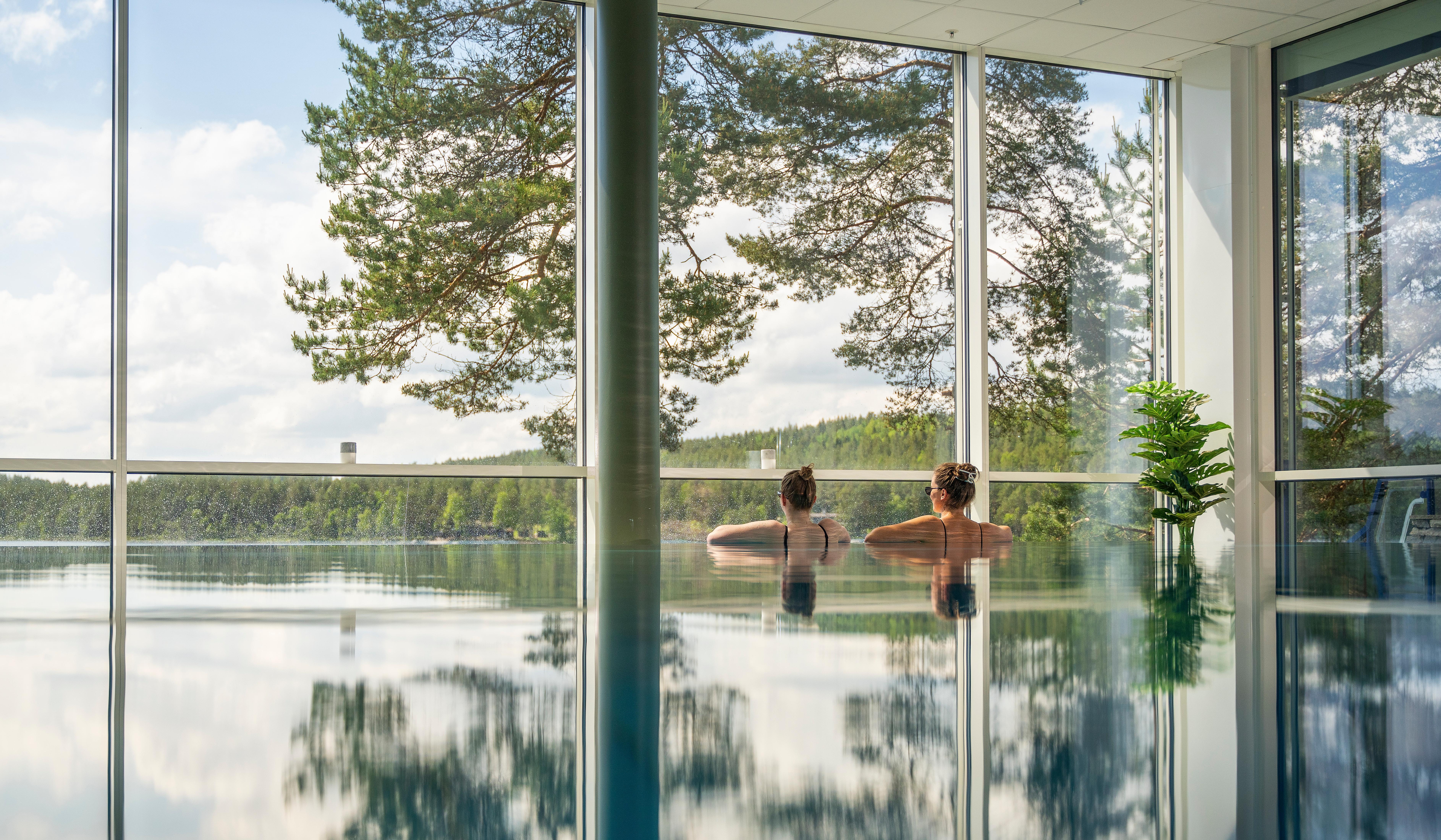 Women enjoying the view from the pool at Rømskog Spa & Resort