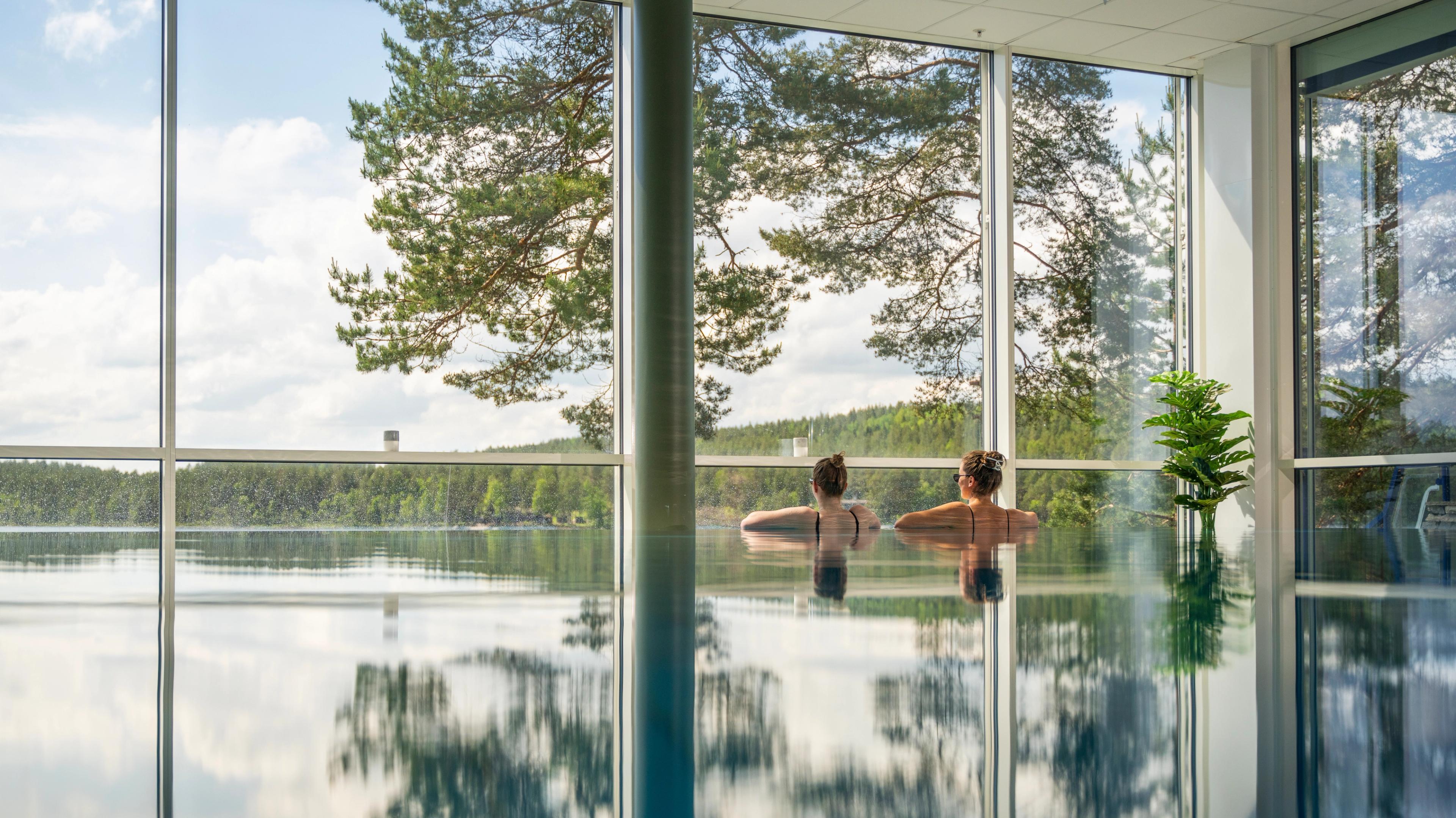 Women enjoying the view from the pool at Rømskog Spa & Resort