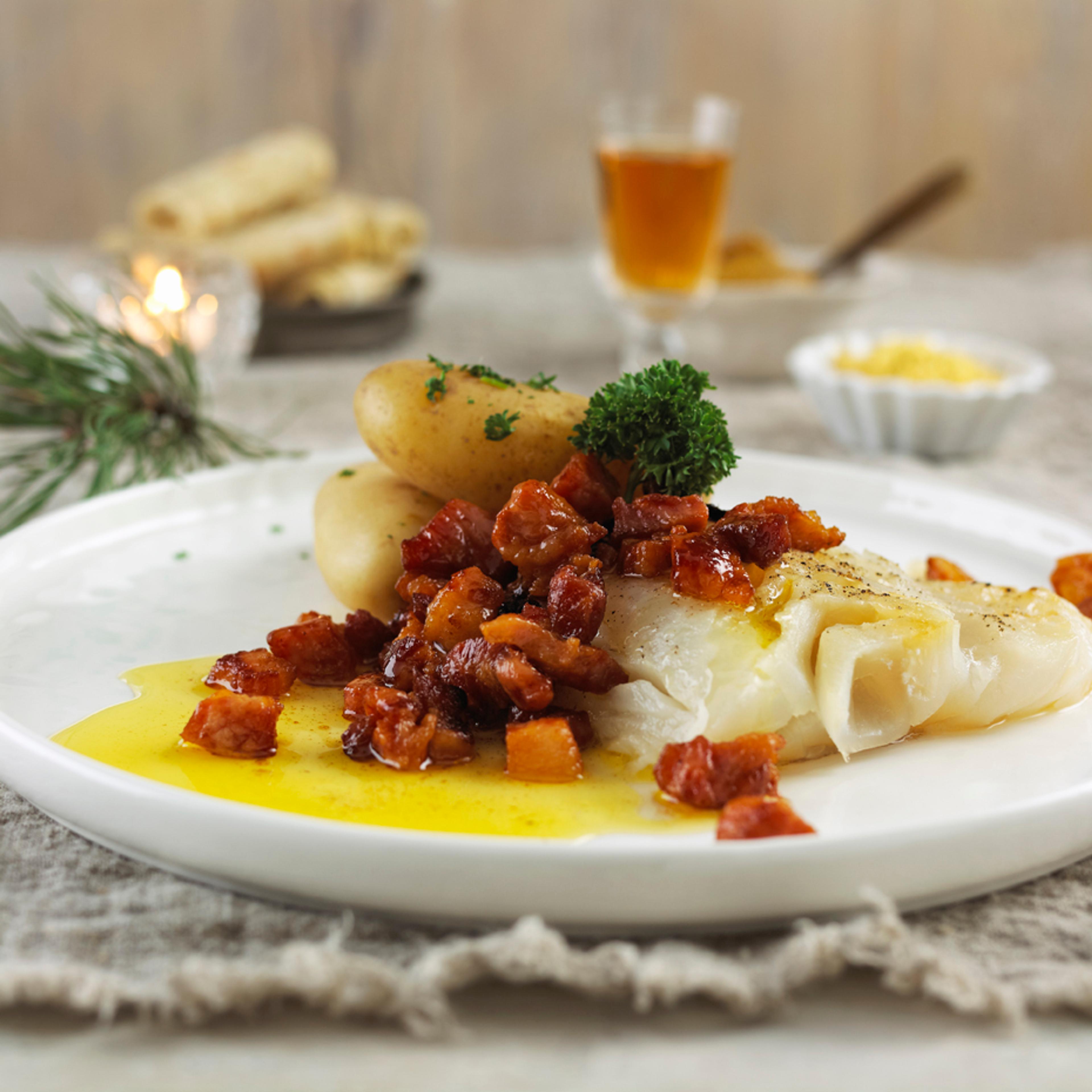 A plate of lutefisk with bacon, potatoes, and parsley