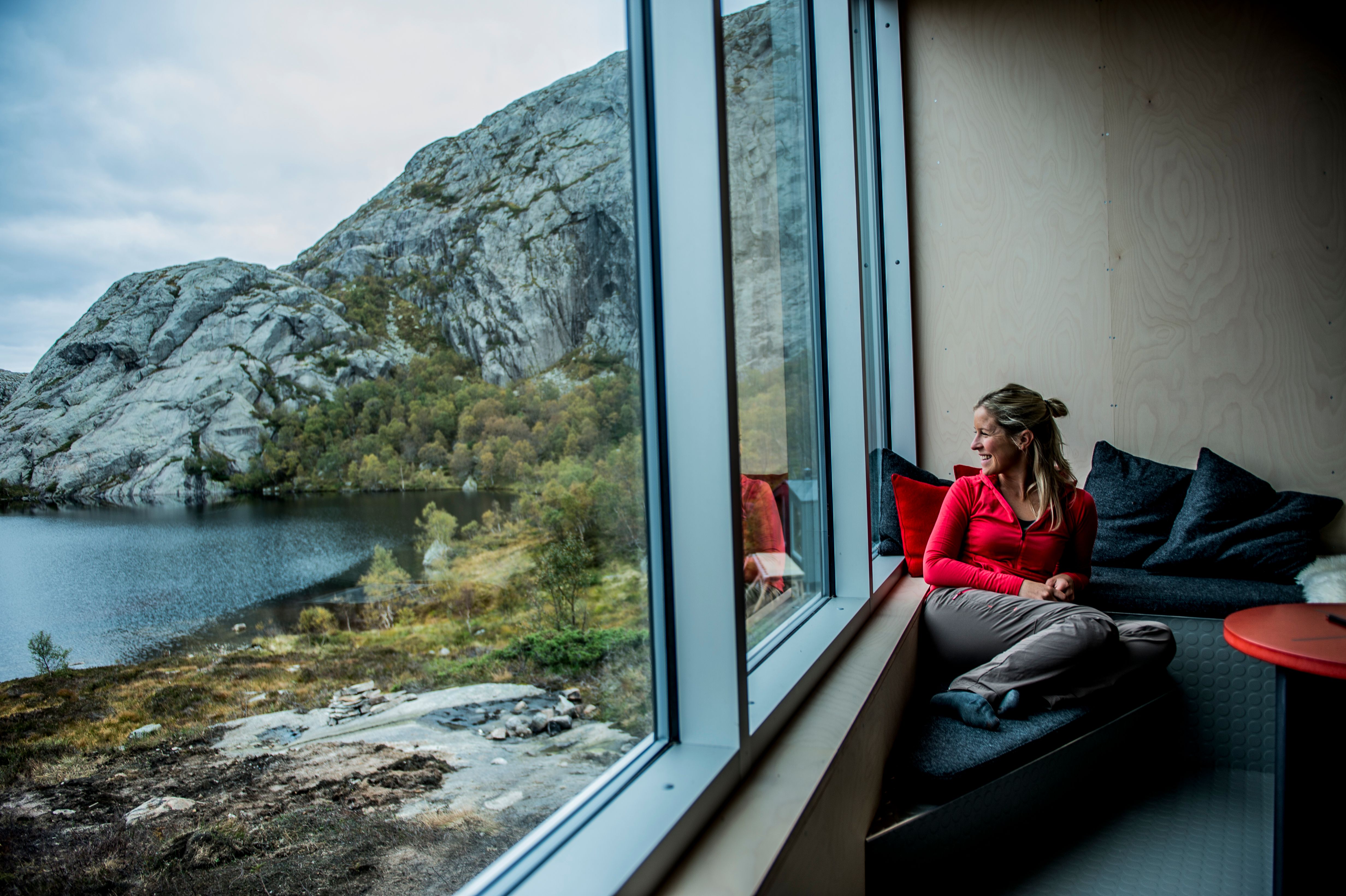 A woman enjoying the view from a cabin.